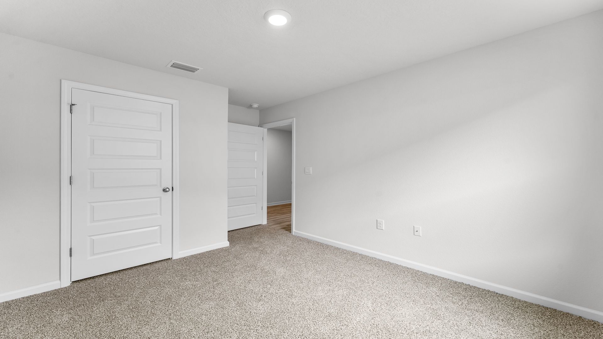 Bedroom with carpet flooring and closet.