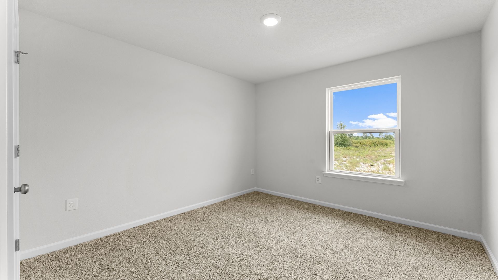 Bedroom with carpet flooring and window and closet.