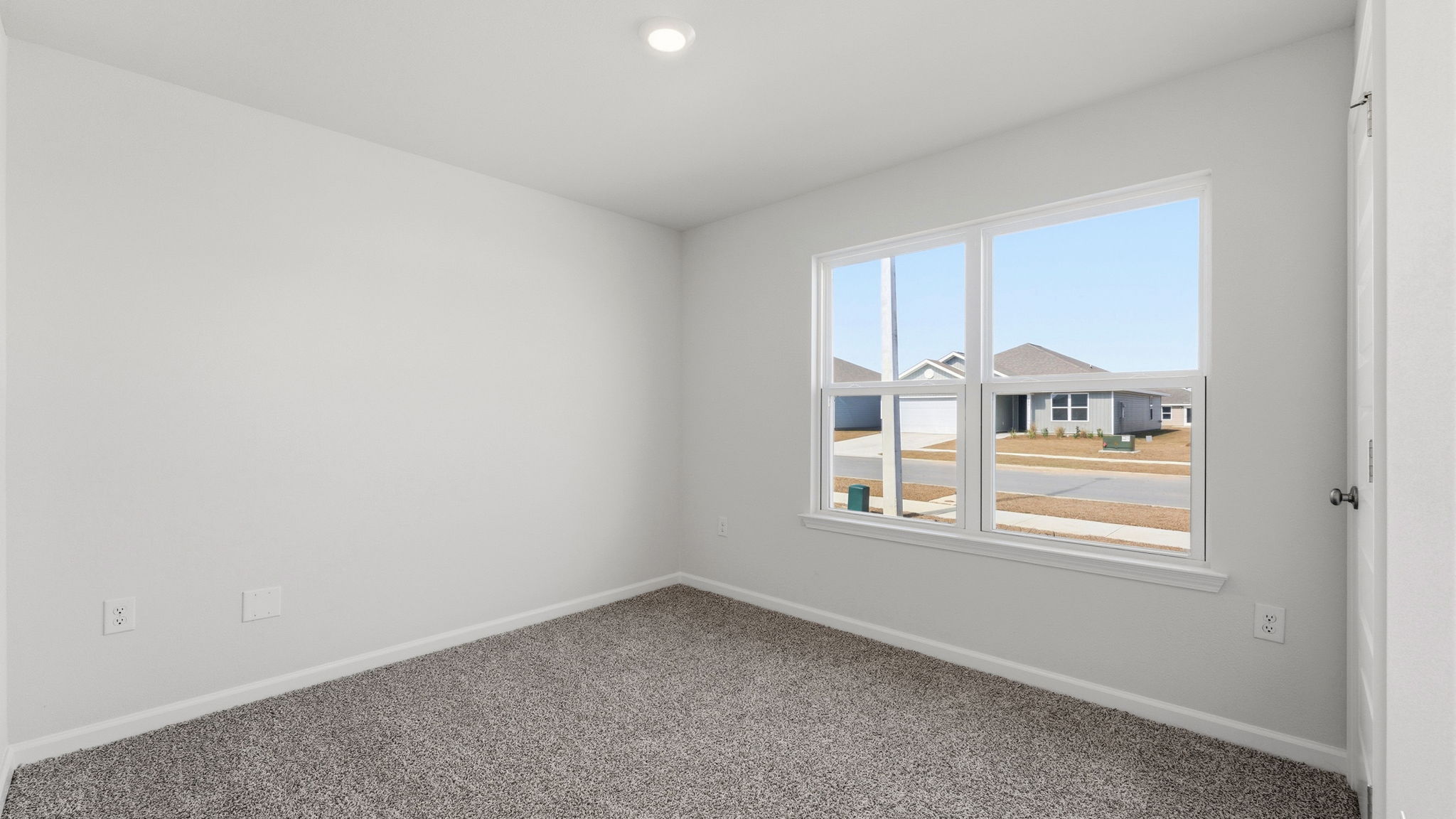 Bedroom with carpet flooring and window and closet.