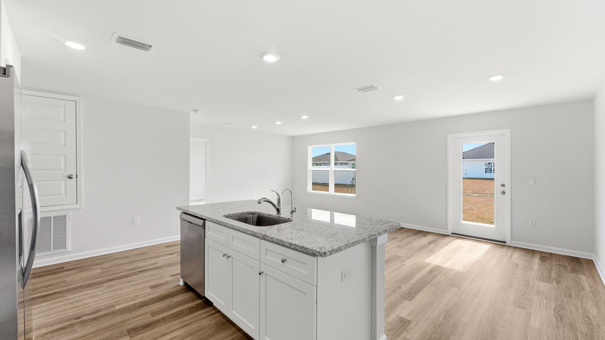 Kitchen and living room view with kitchen island.