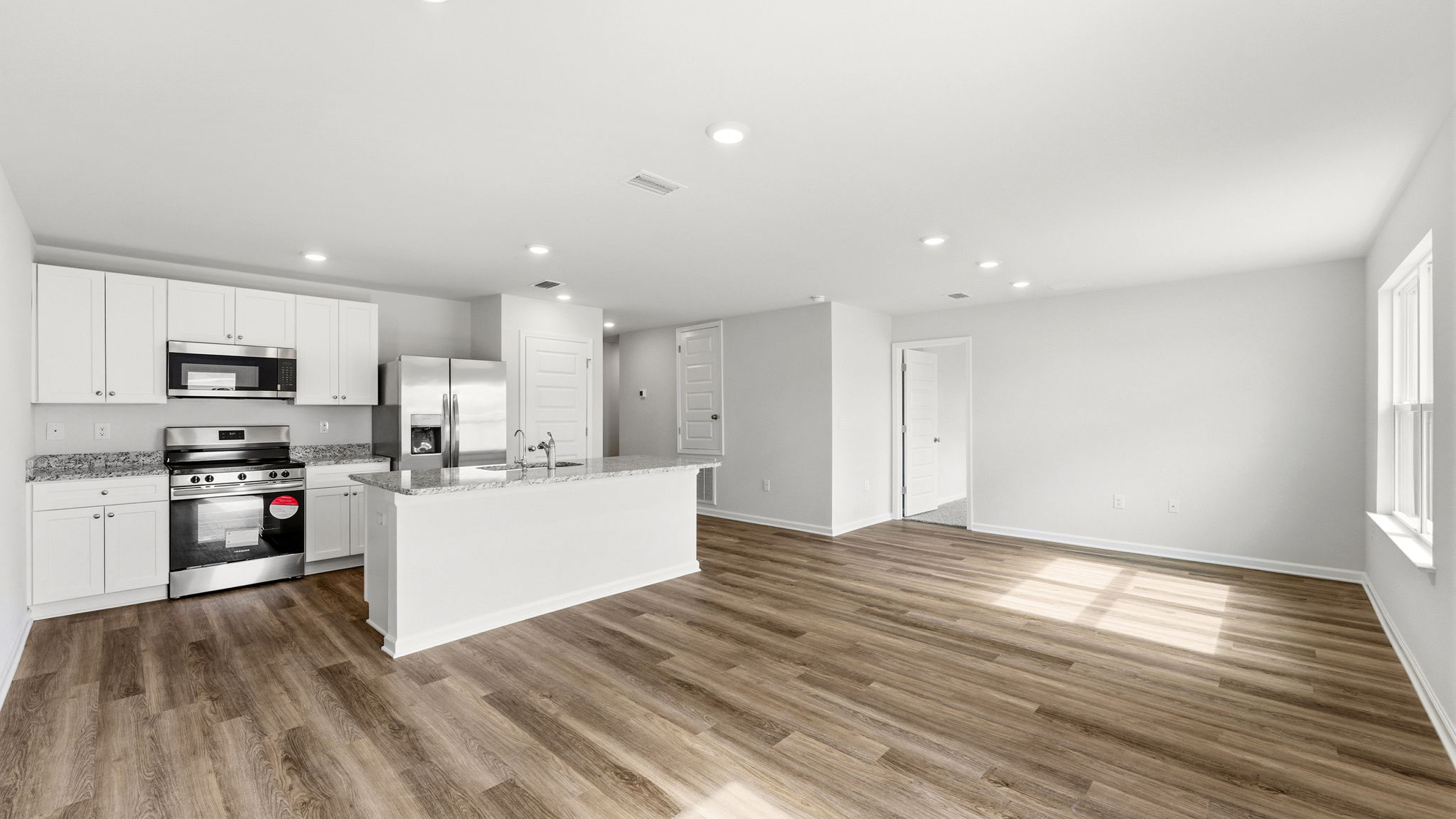Dining room view of kitchen and living room.