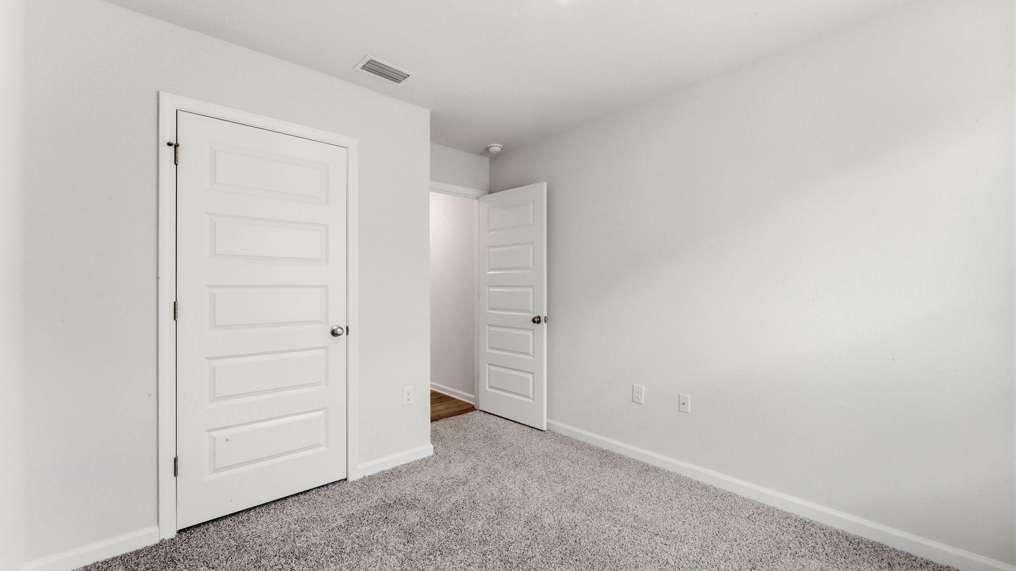 Bedroom with carpet flooring and closet.