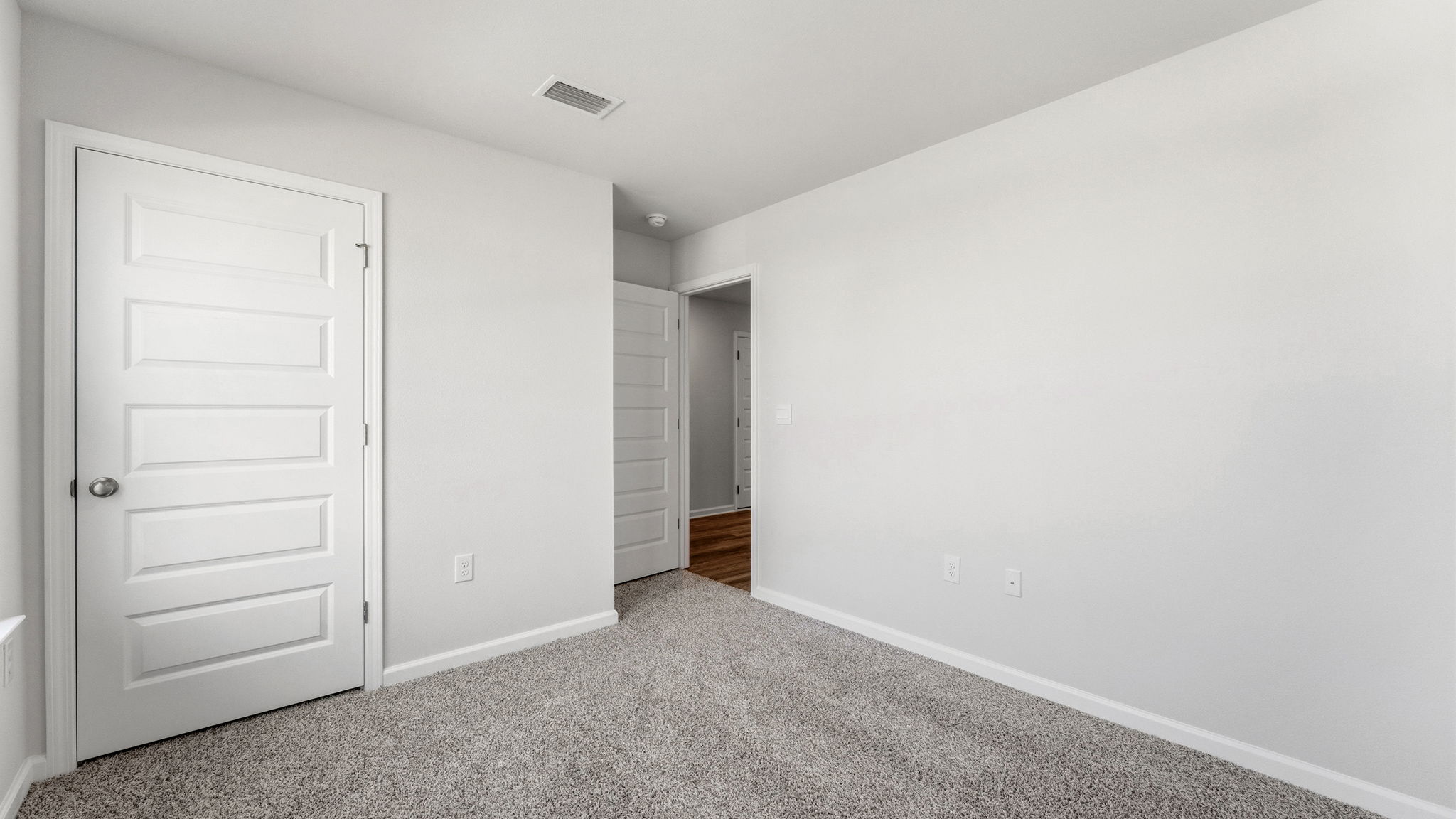 Bedroom with carpet flooring and closet.