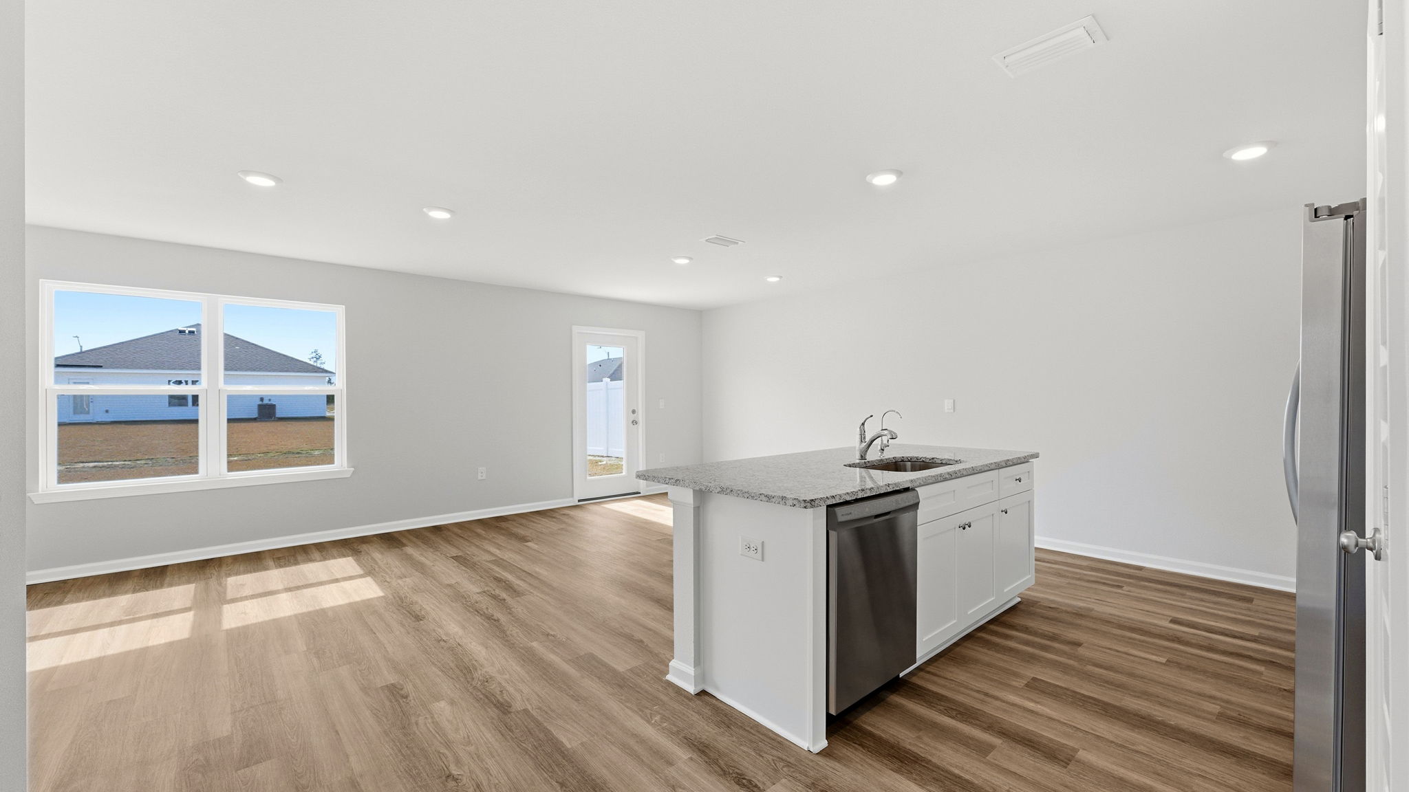 Kitchen and living room view with kitchen island.