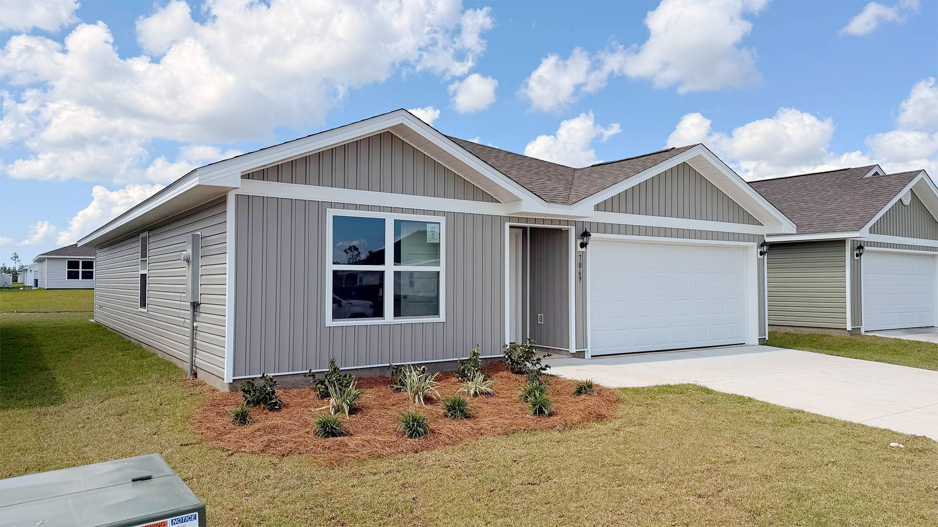 Freeport floor plan at Liberty with vinyl siding and two-car garage.