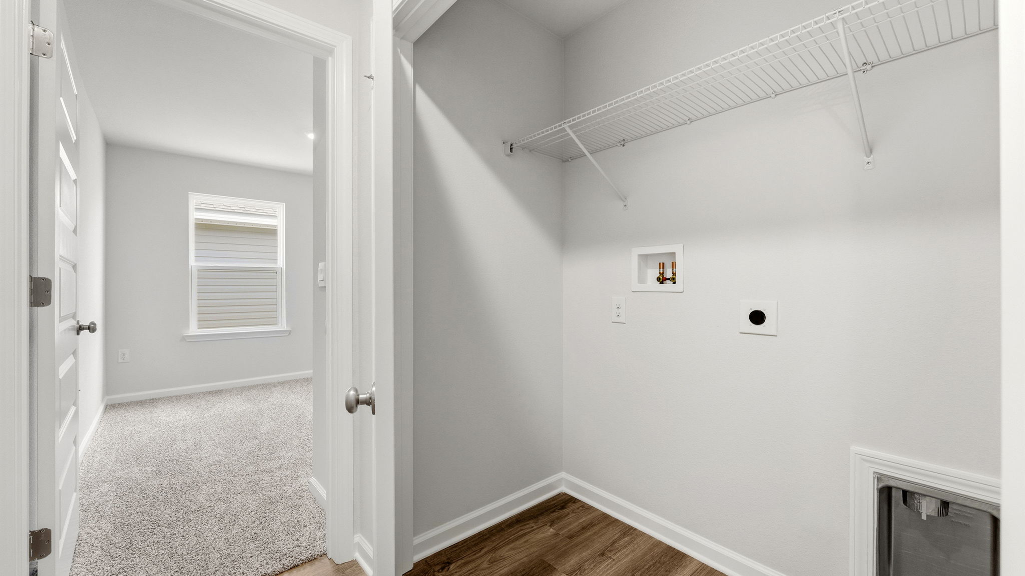Laundry room with EVP flooring and ventilated shelving.
