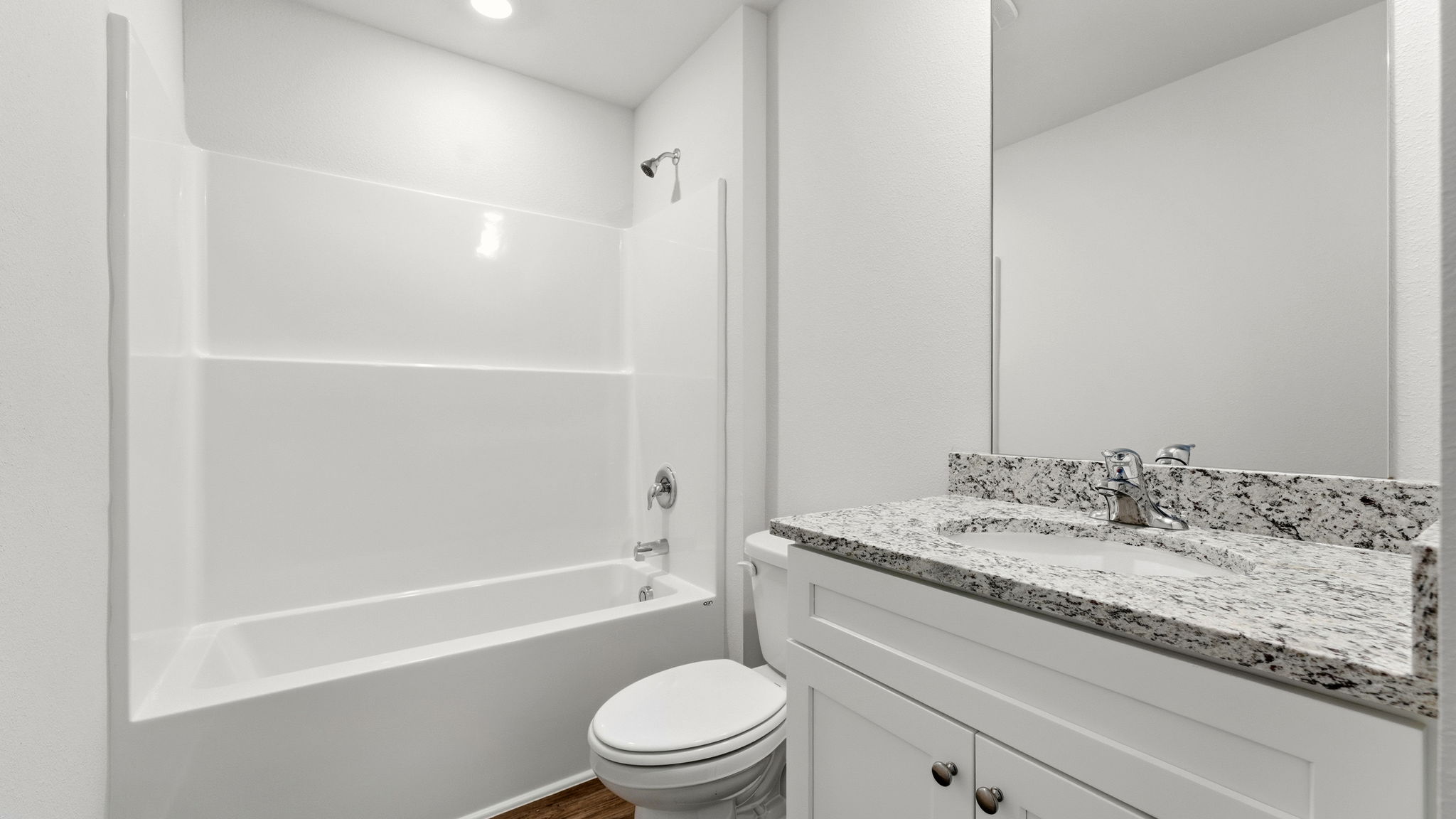 Bathroom with granite countertops and single vanity and shower and tub.