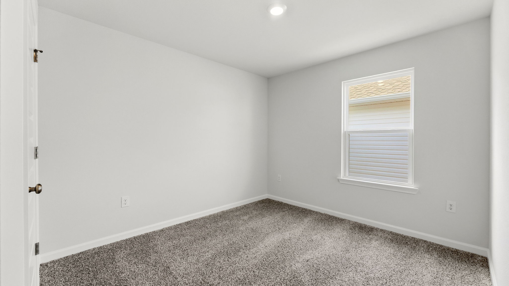 Bedroom with carpet flooring and window and closet.