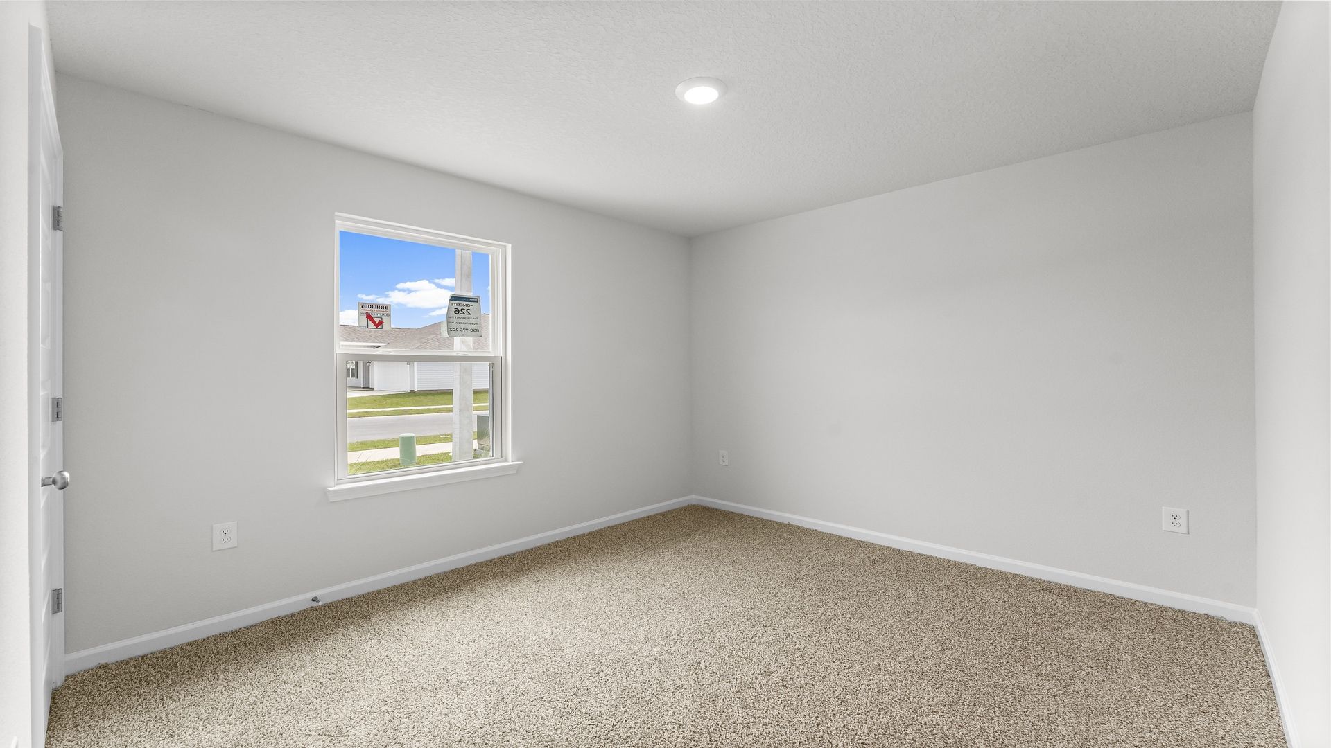 Bedroom with carpet flooring and window and closet.