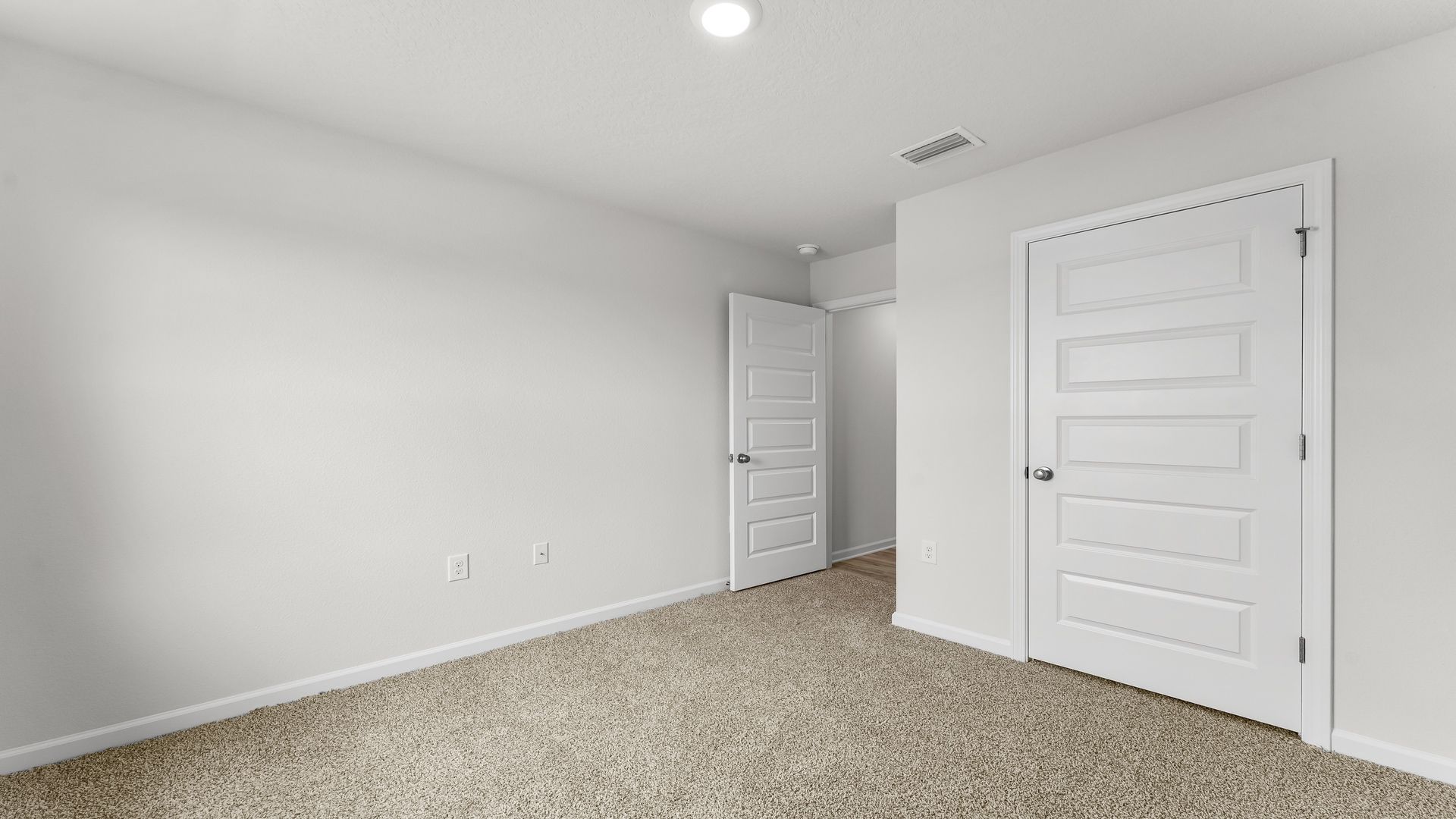 Bedroom with carpet flooring and closet.