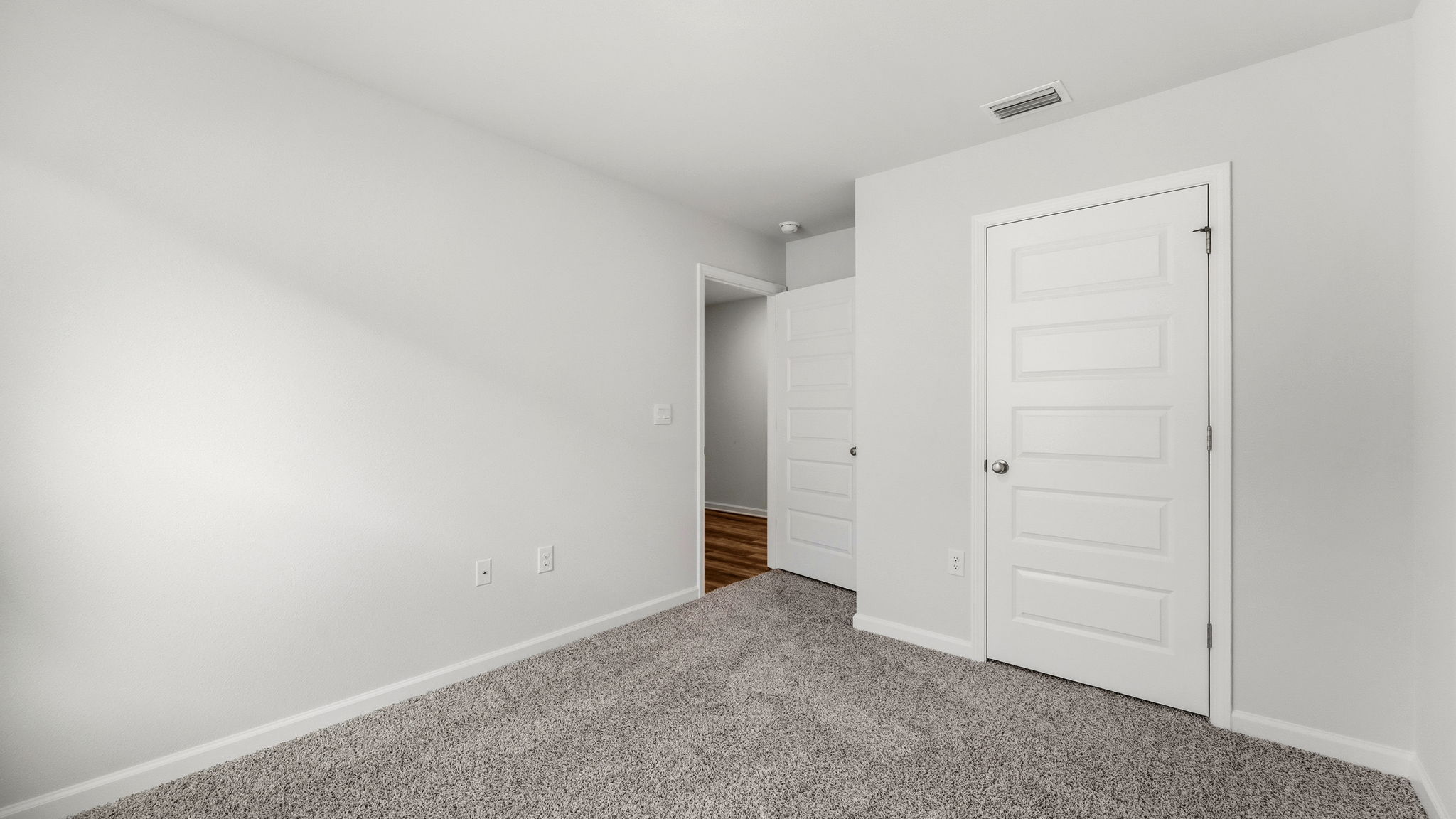 Bedroom with carpet flooring and closet.