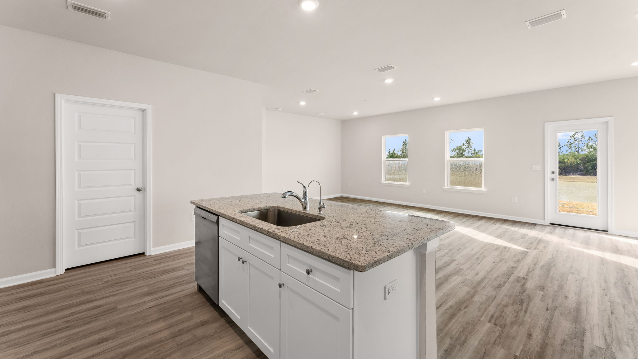Living room and kitchen view next to pantry.