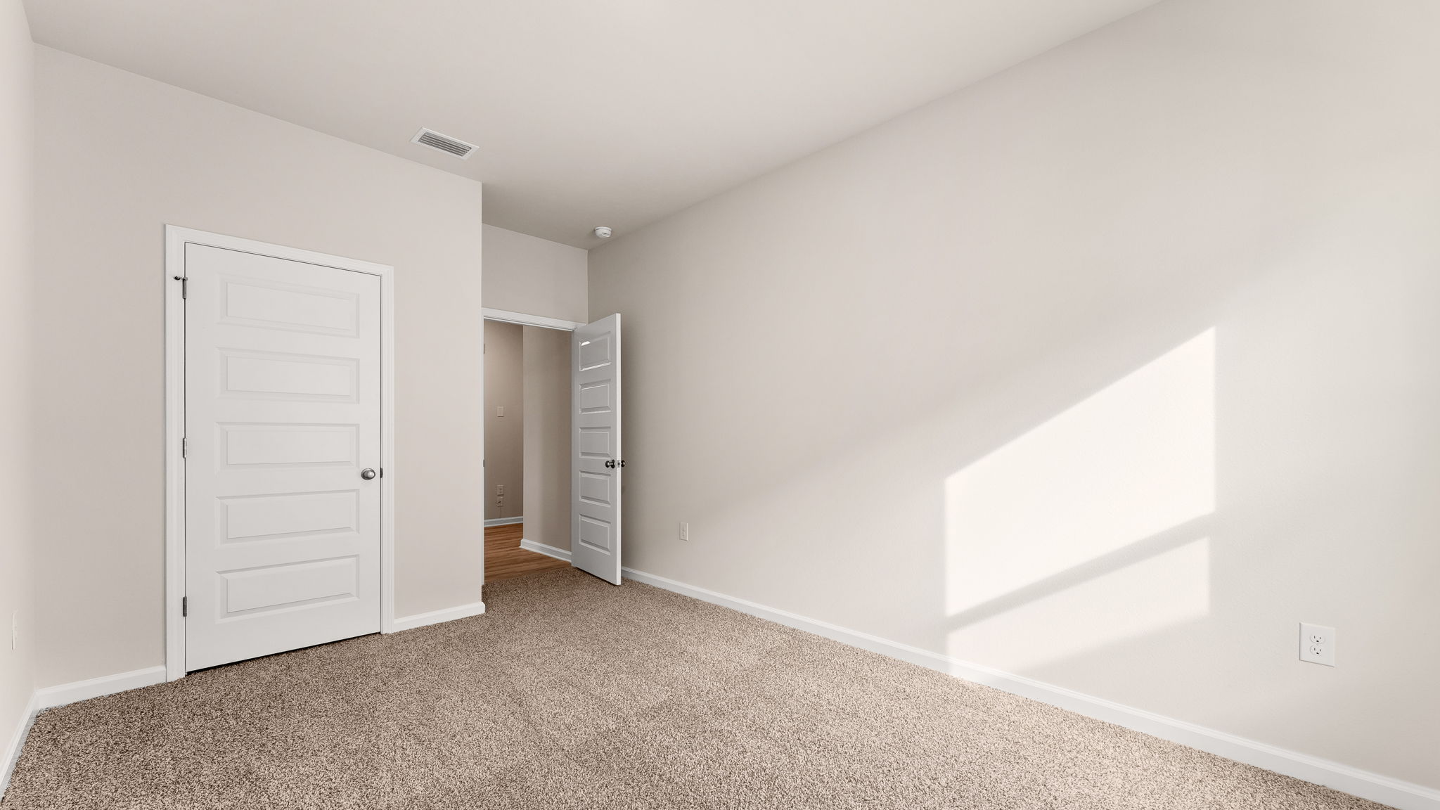 Bedroom with carpet floor and closet.