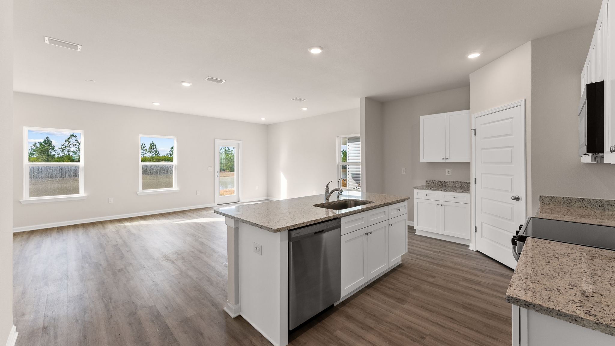 Living room and kitchen view next to hallway.