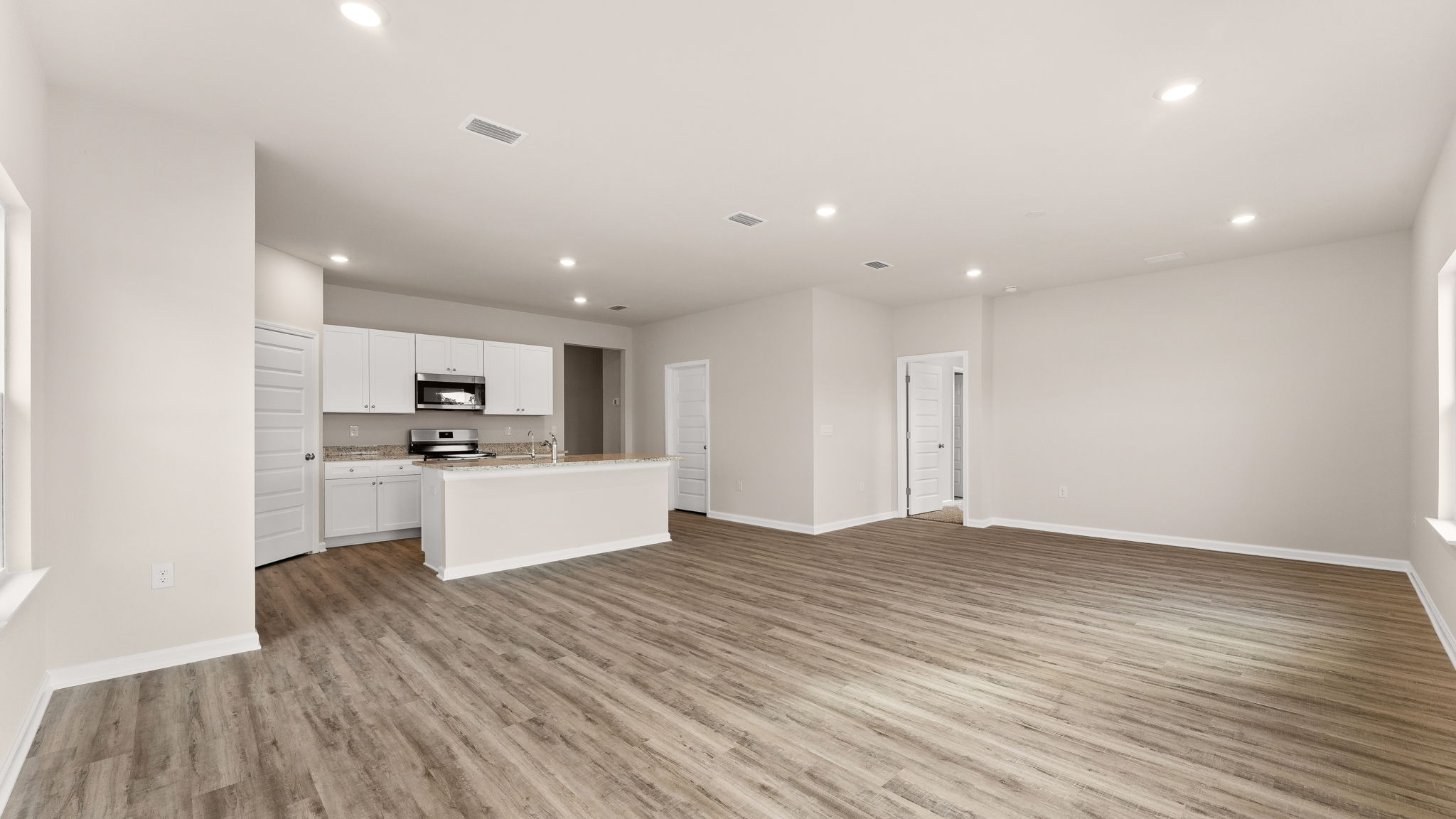 Living room and dining area next to back door.