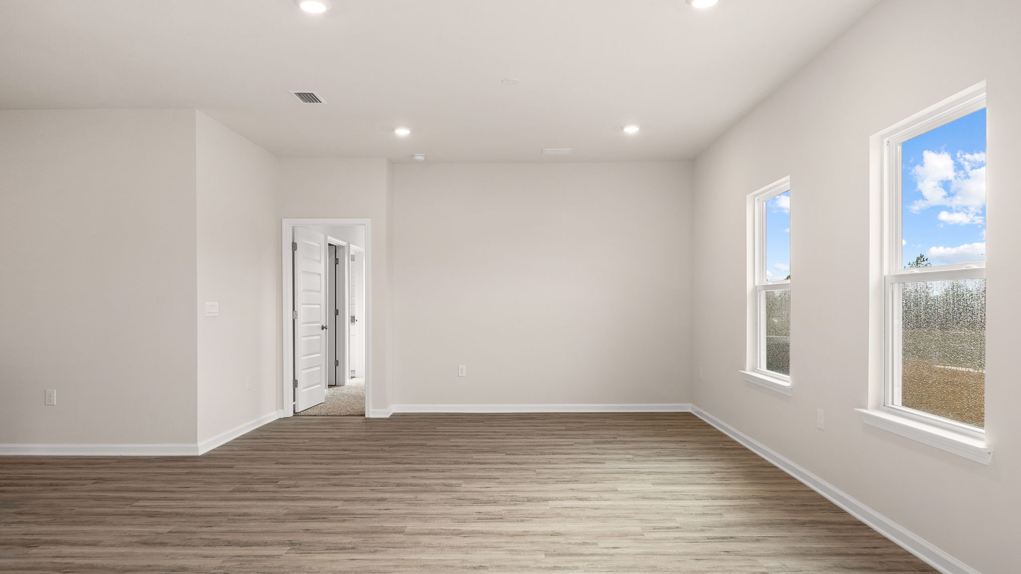 Living room and dining area next to back door.
