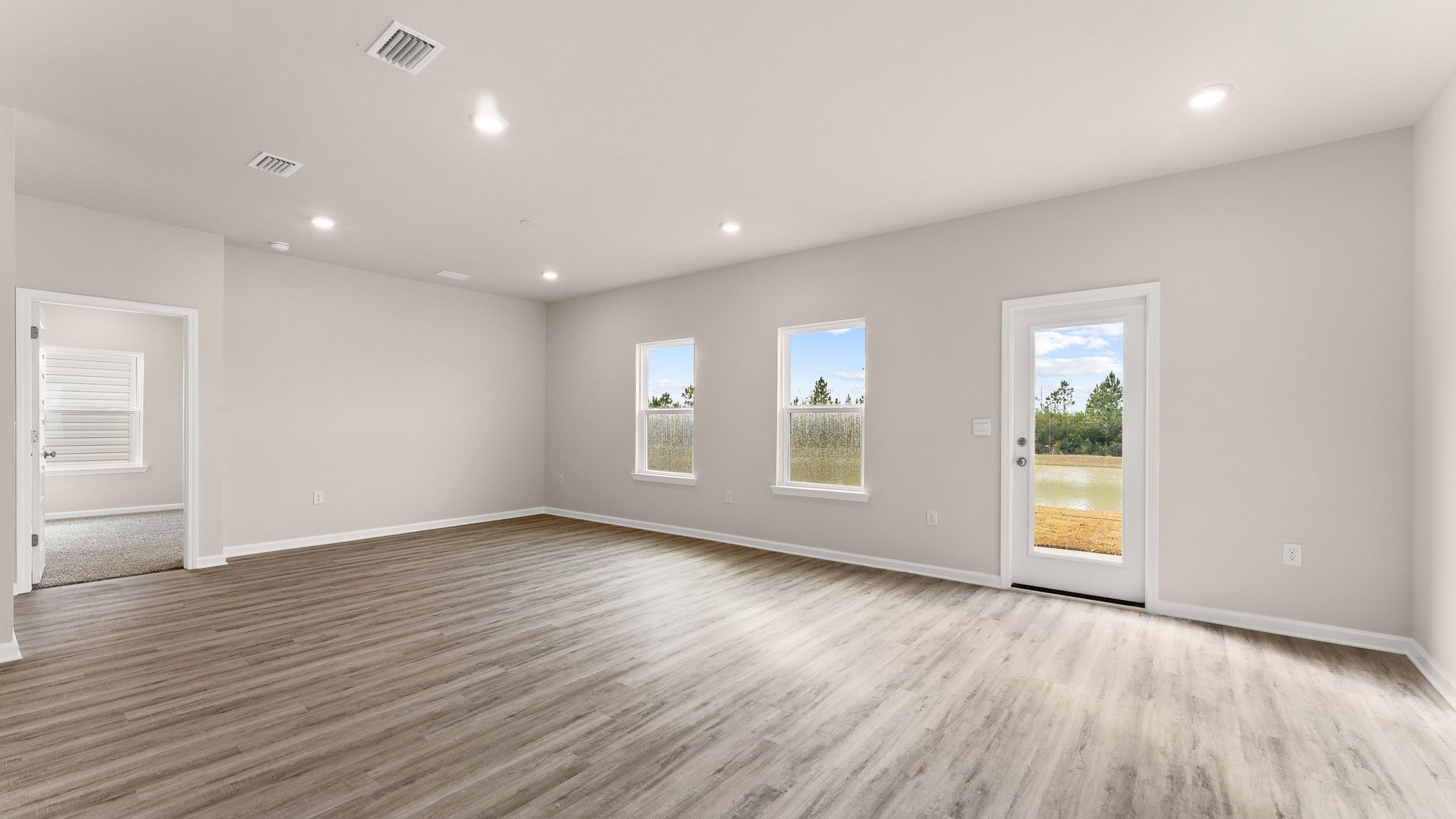 Living room and dining area next to back door.