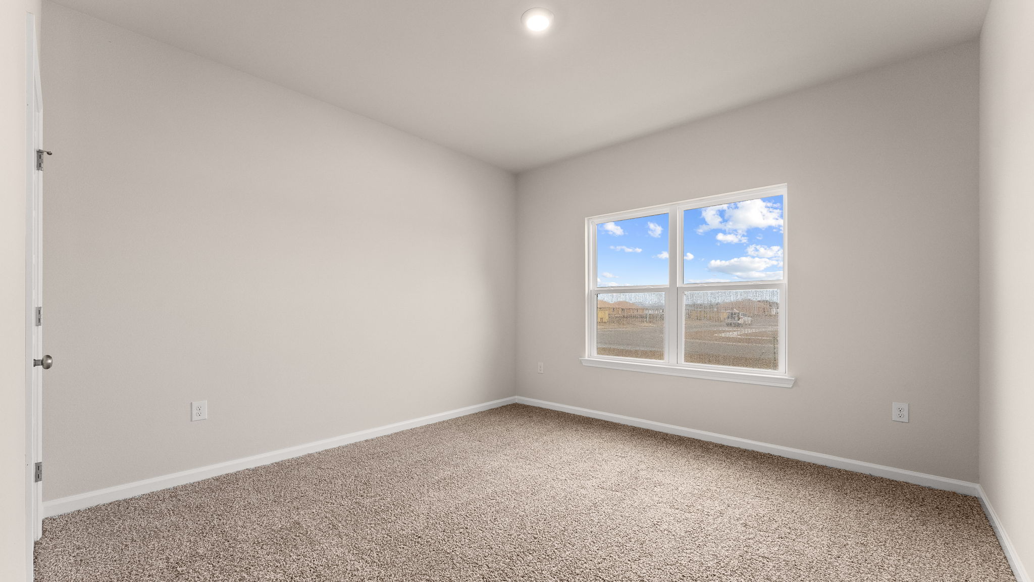 Bedroom with carpet floor and windows and closet.