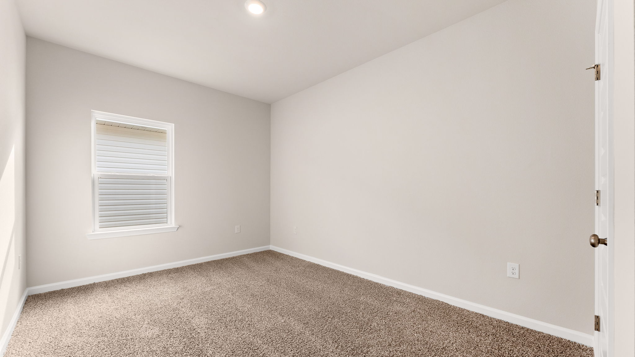 Bedroom with carpet floor and window and closet.