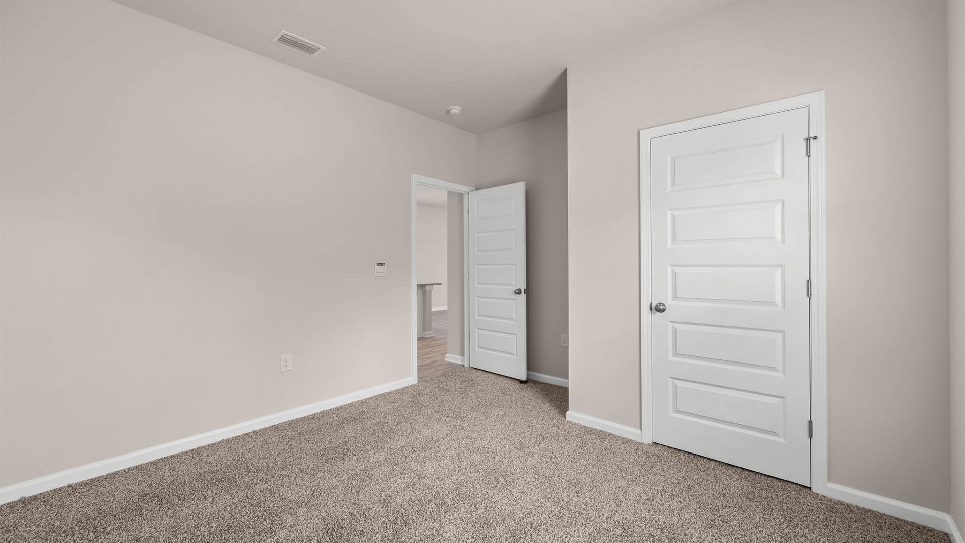 Bedroom with closet and carpet floors.