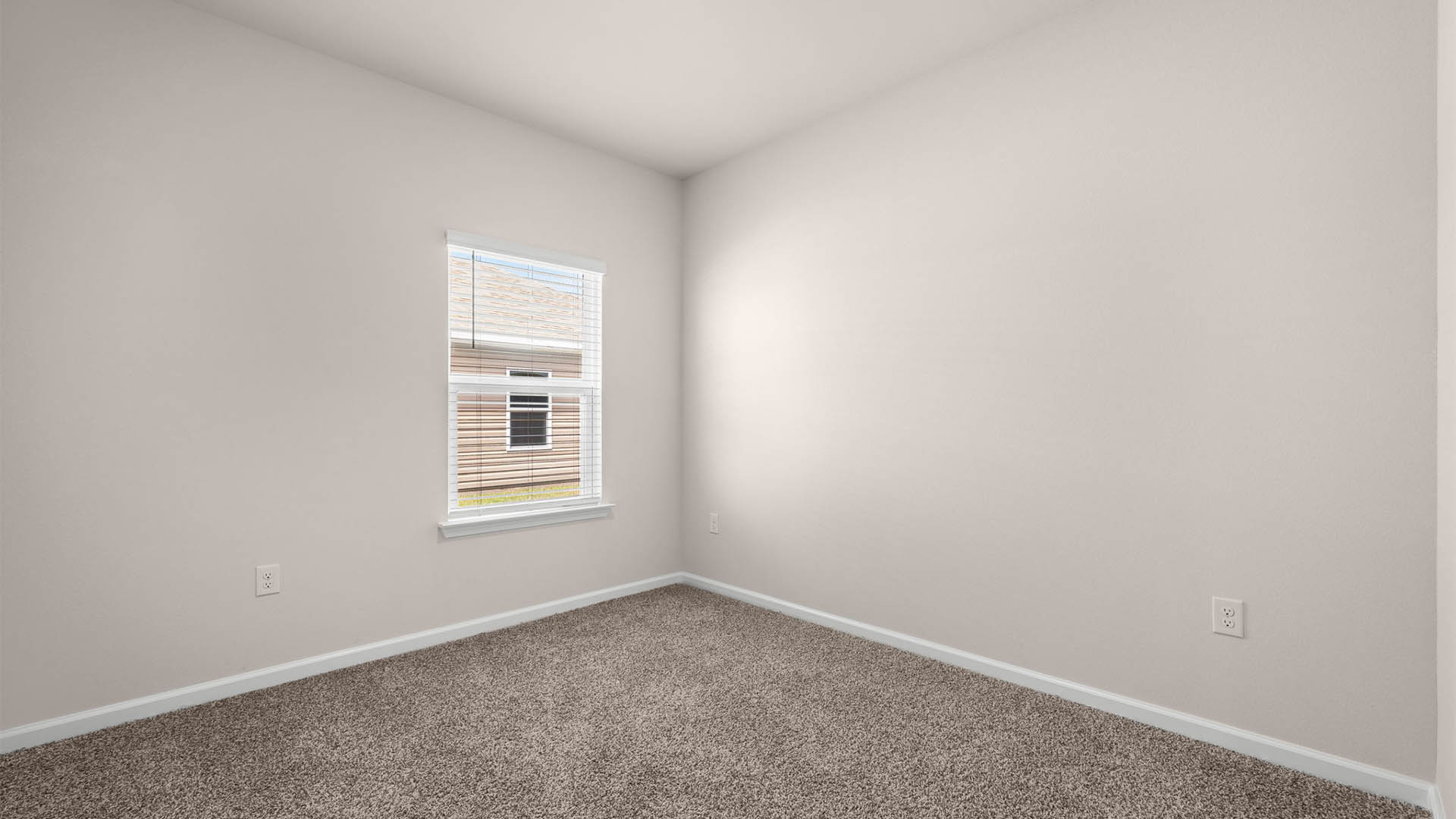 Bedroom with window and carpet floors.