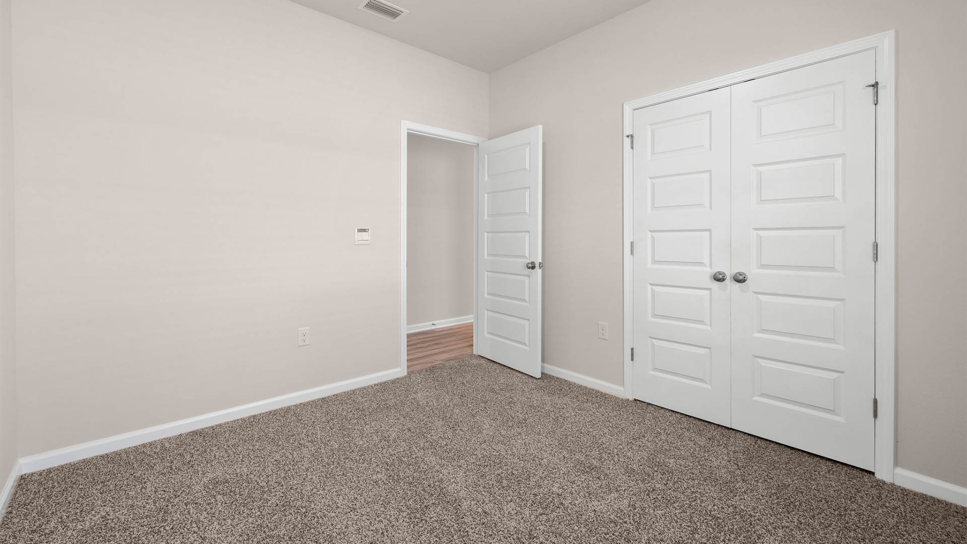 Bedroom with closet and carpet floors.