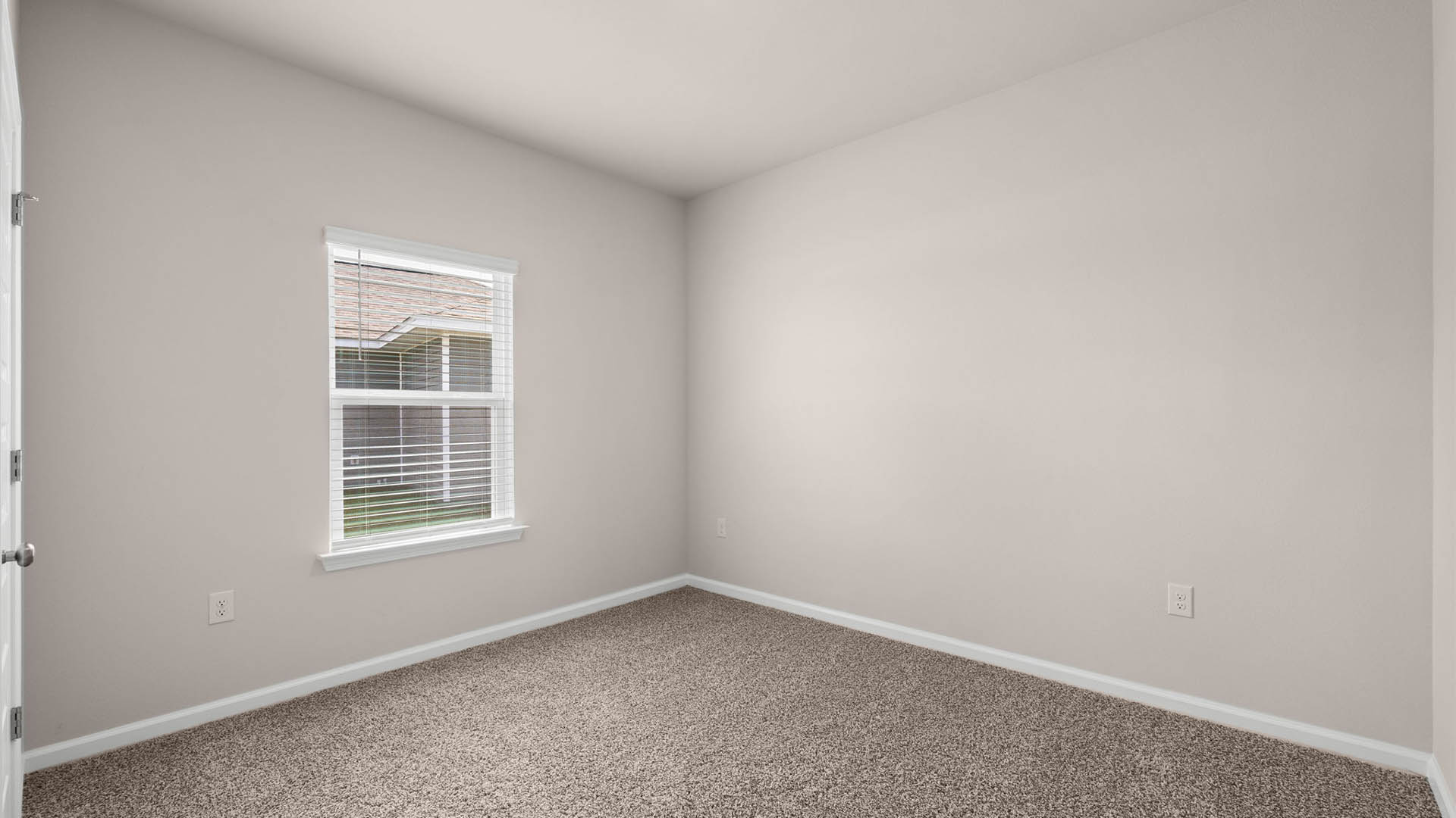 Bedroom with window and carpet floors.