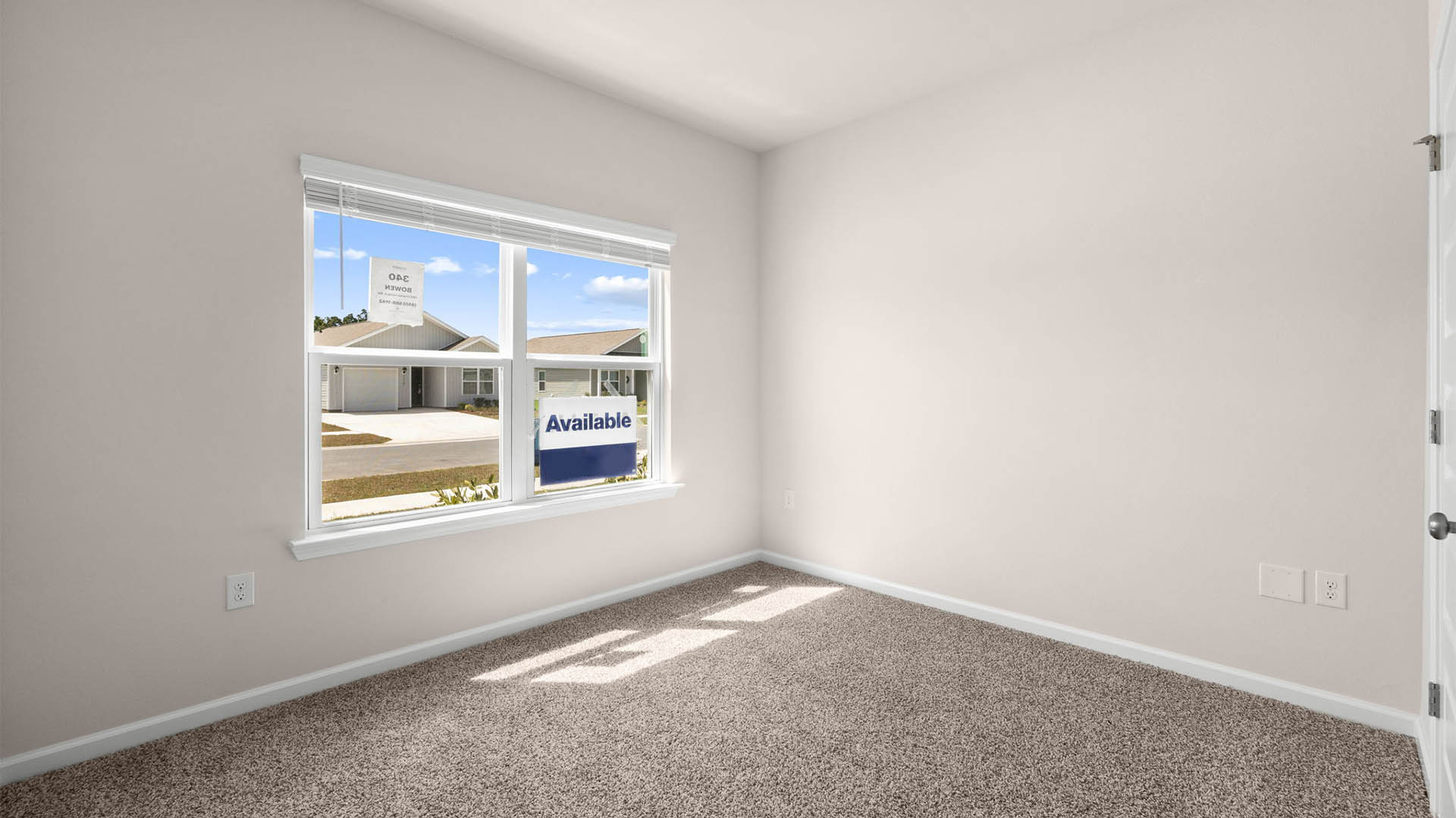 Bedroom with window and carpet floors.