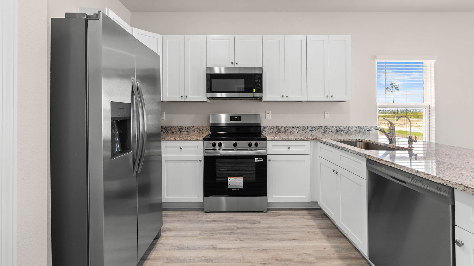 Kitchen with granite countertops and stainless-steel appliances and pantry.
