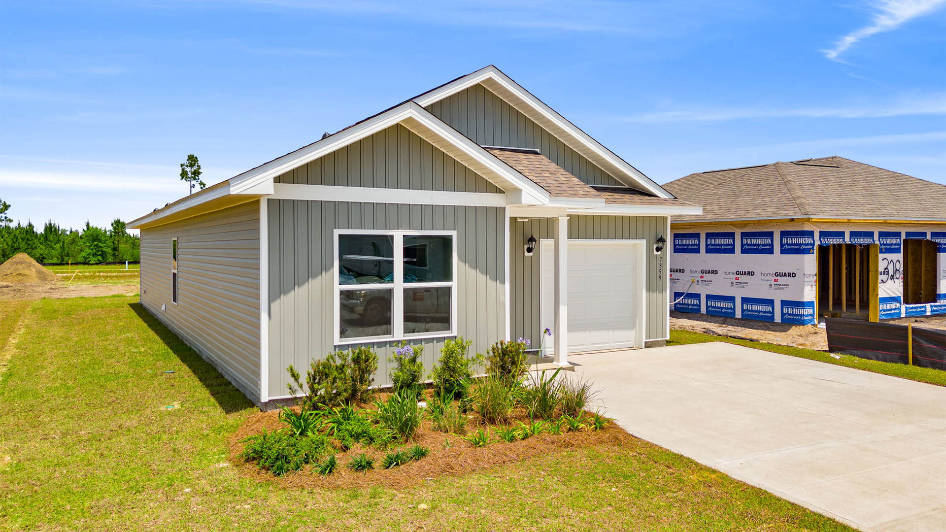 Poppy plan with vinyl siding and single car garage.
