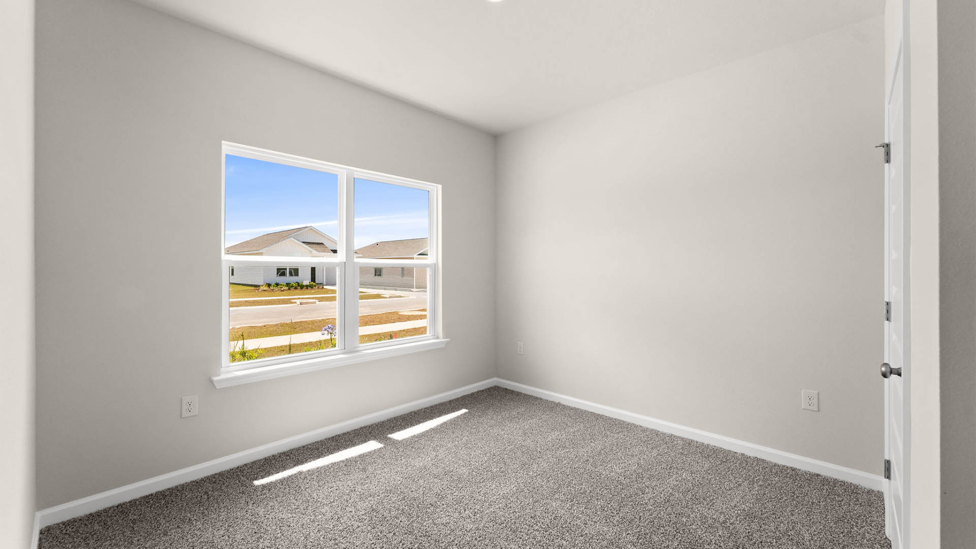 Bedroom with window and carpet floors.