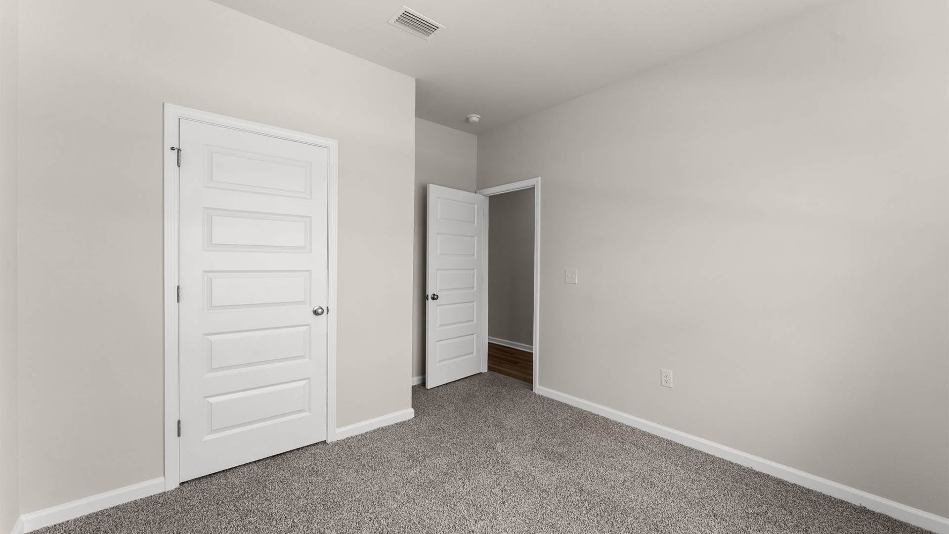 Bedroom with closet and carpet floors.