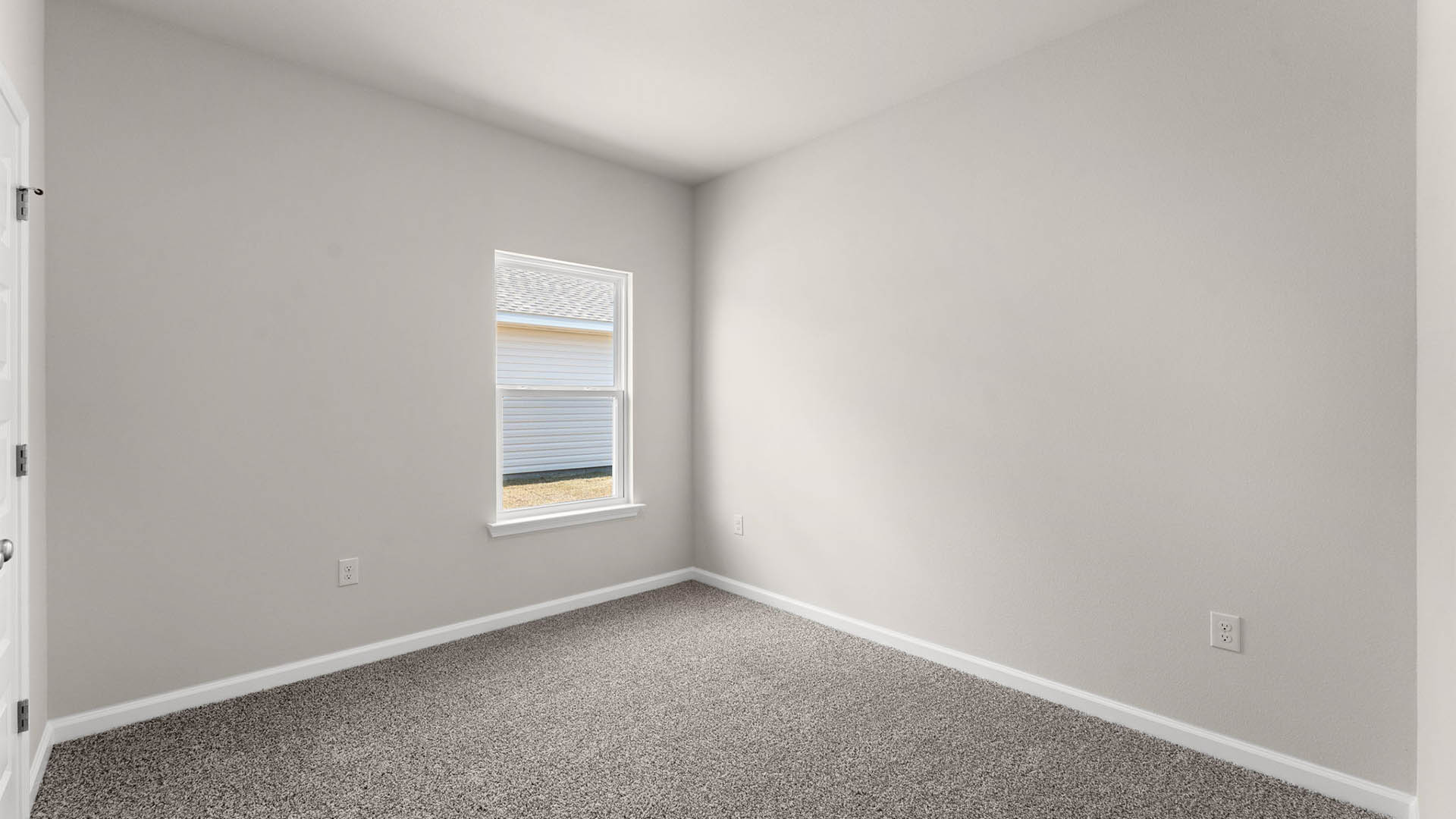 Bedroom with window and carpet floors.