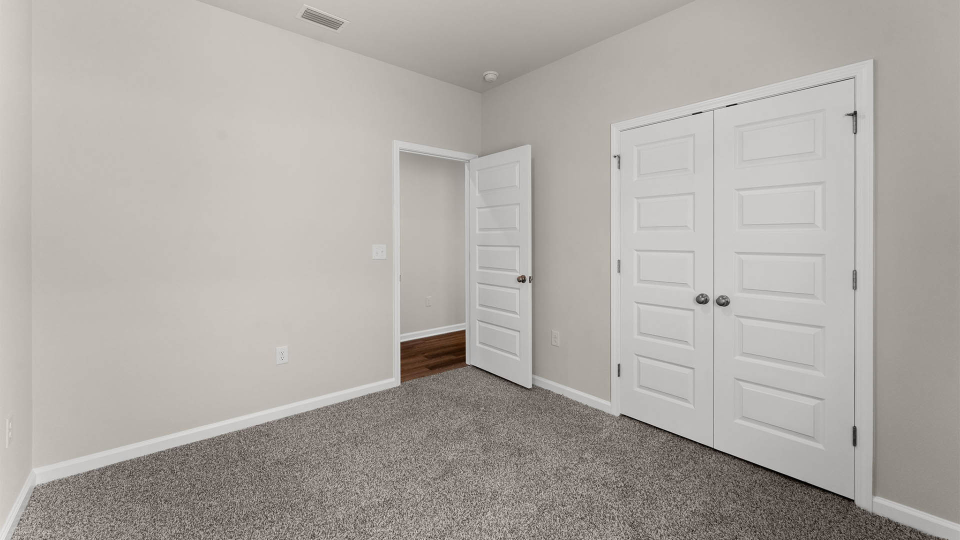 Bedroom with closet and carpet floors.