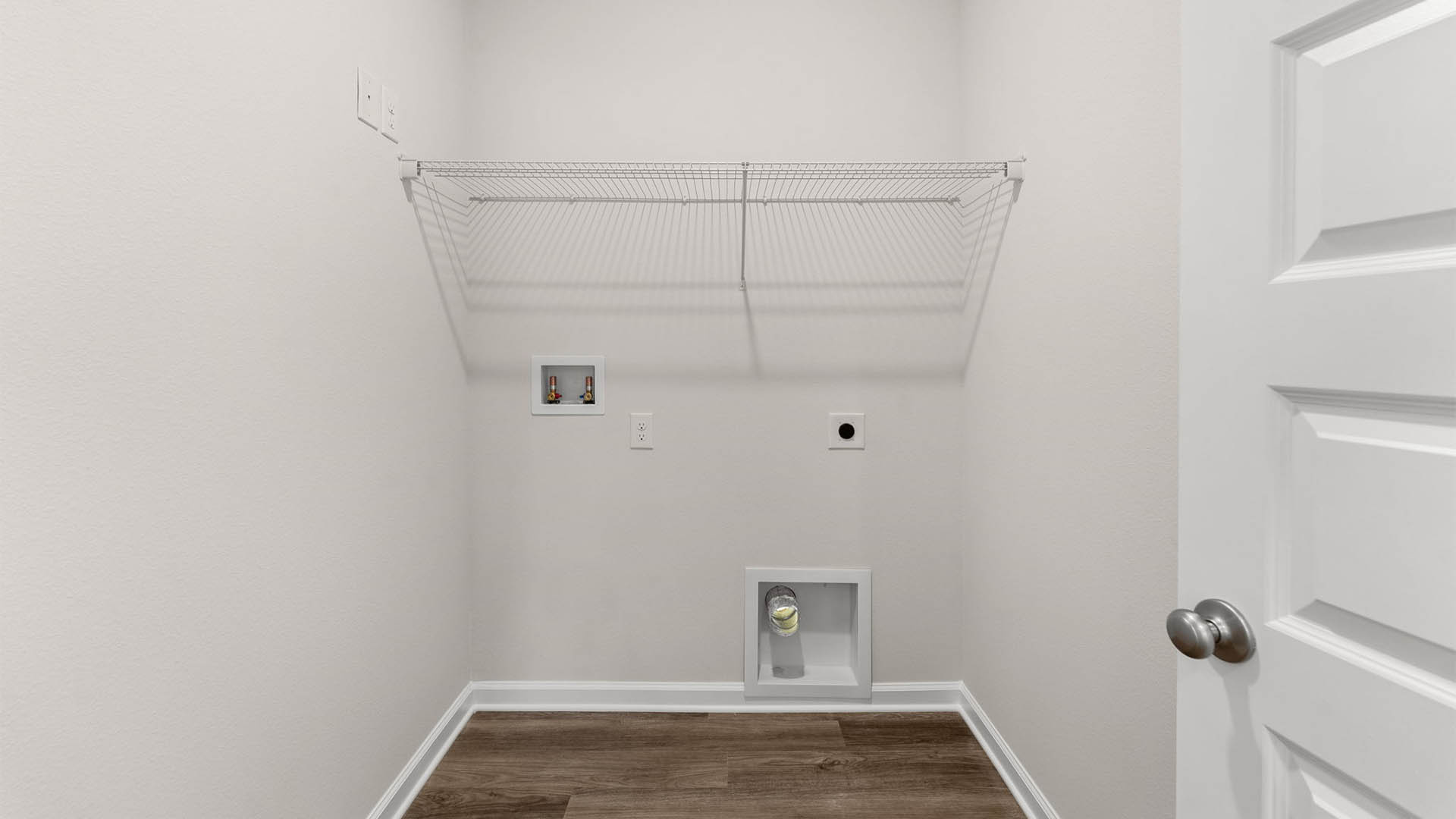 Laundry room with shelving and EVP floors and closet.