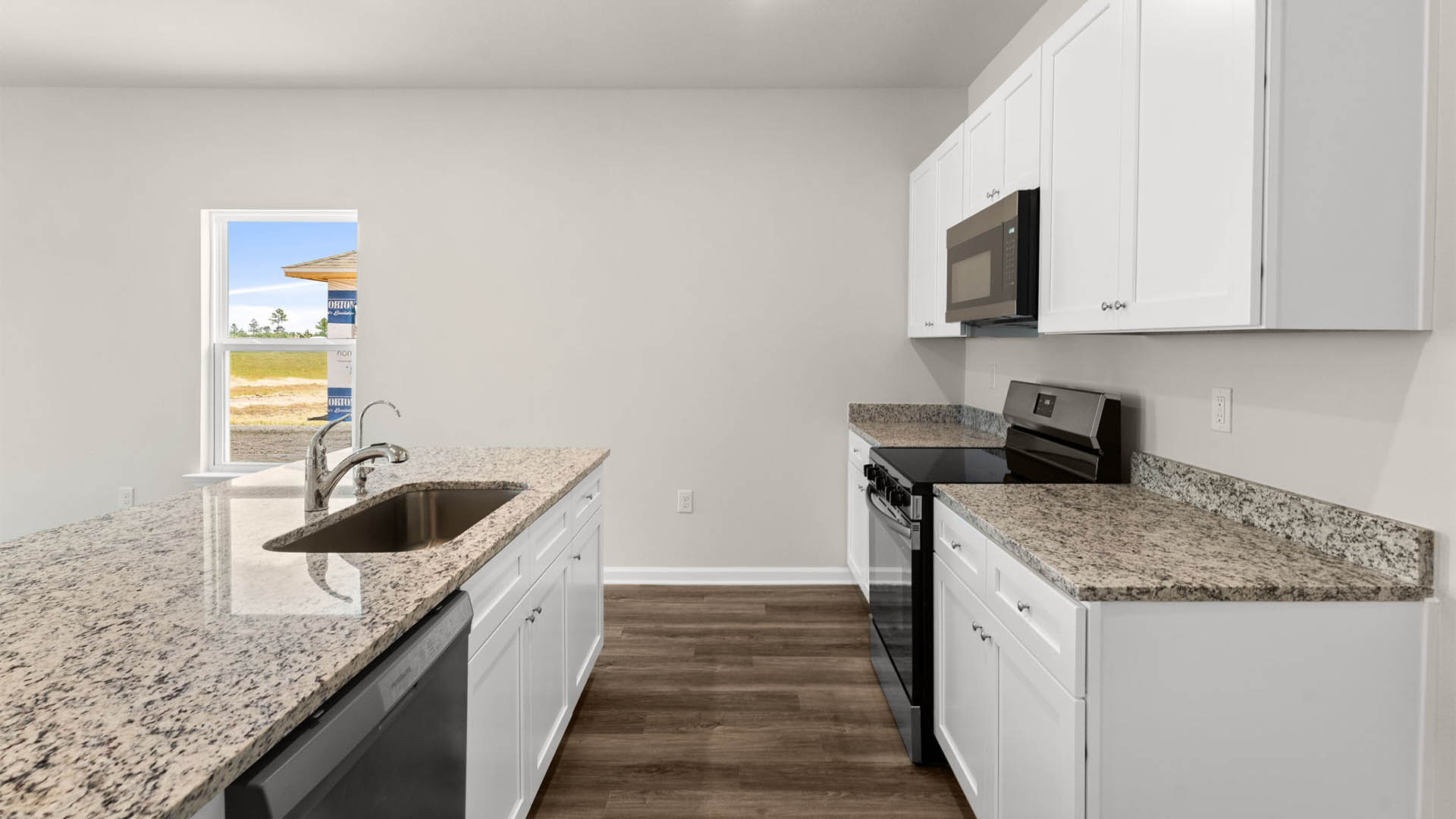 Kitchen with granite countertops and stainless-steel appliances and pantry.