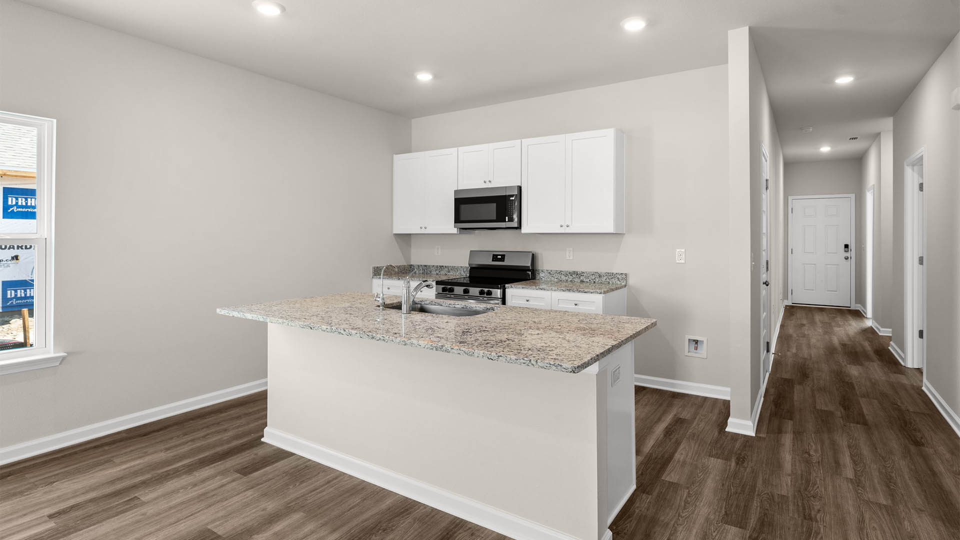 Kitchen with granite countertops and stainless-steel appliances and pantry.