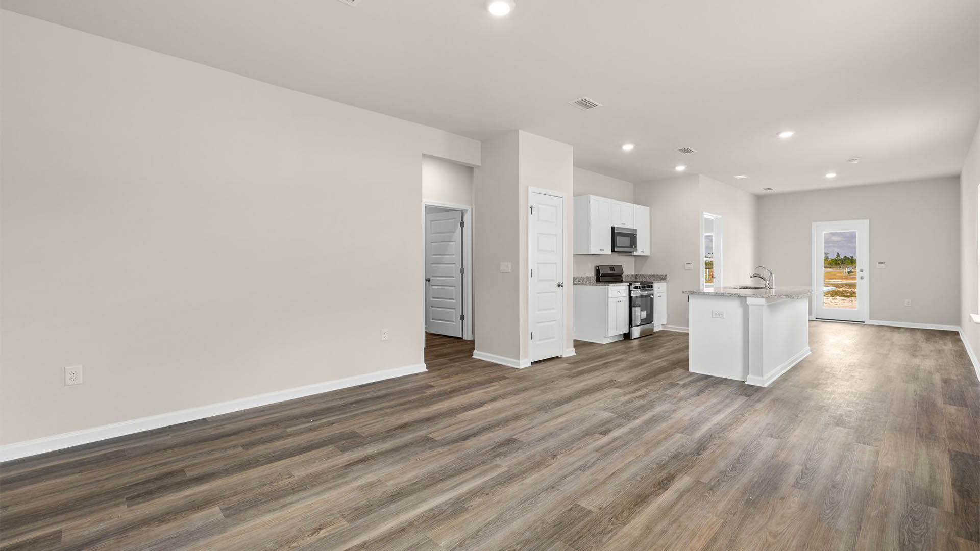 Open living room and kitchen with EVP flooring.