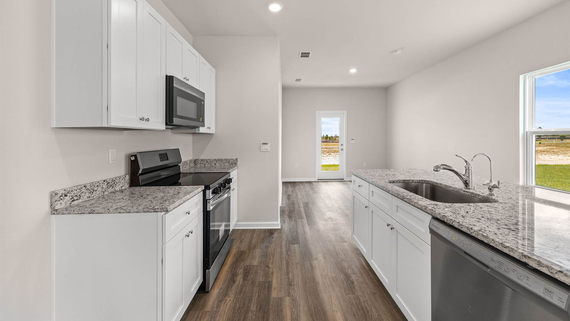 Kitchen with granite countertops and stainless-steel appliances and pantry.