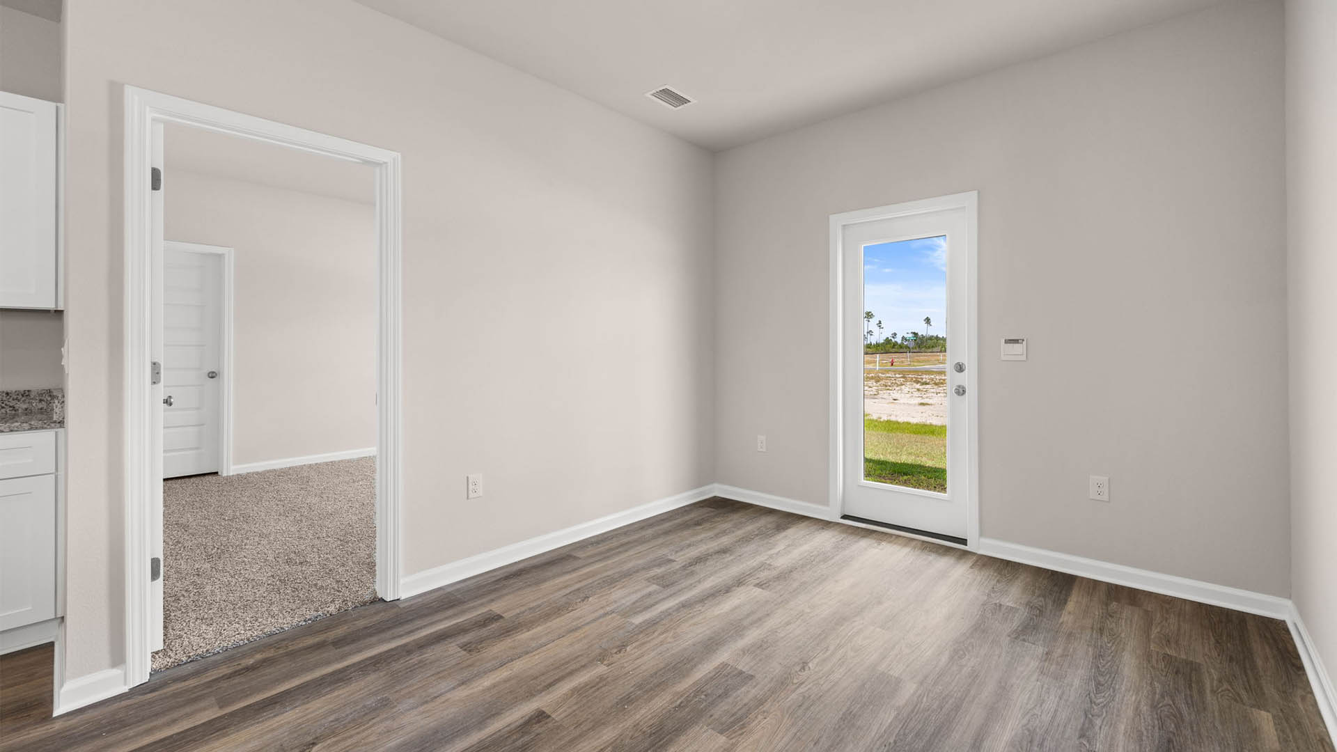 Dining area with EVP flooring next to back door.