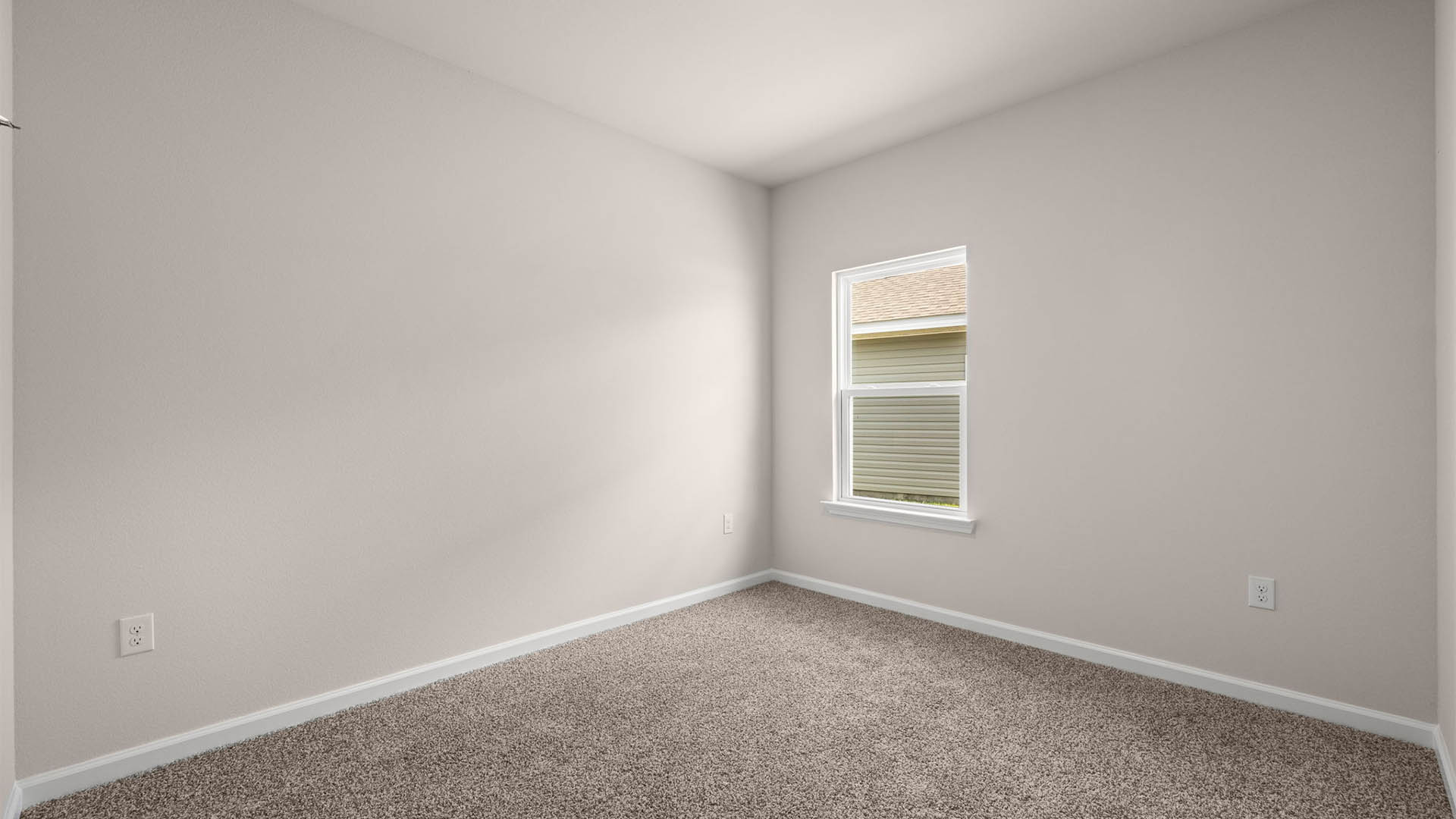 Bedroom with carpet floor and window.