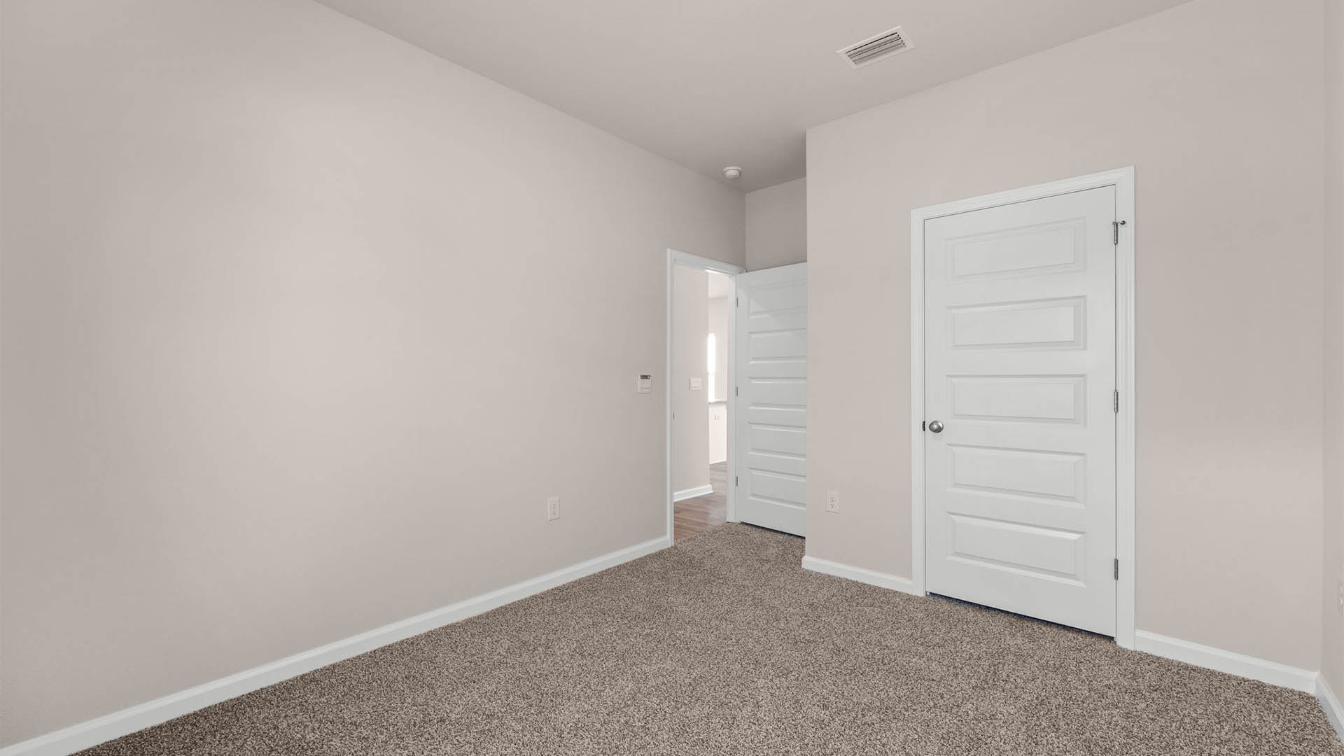 Bedroom with carpet floor and closet.