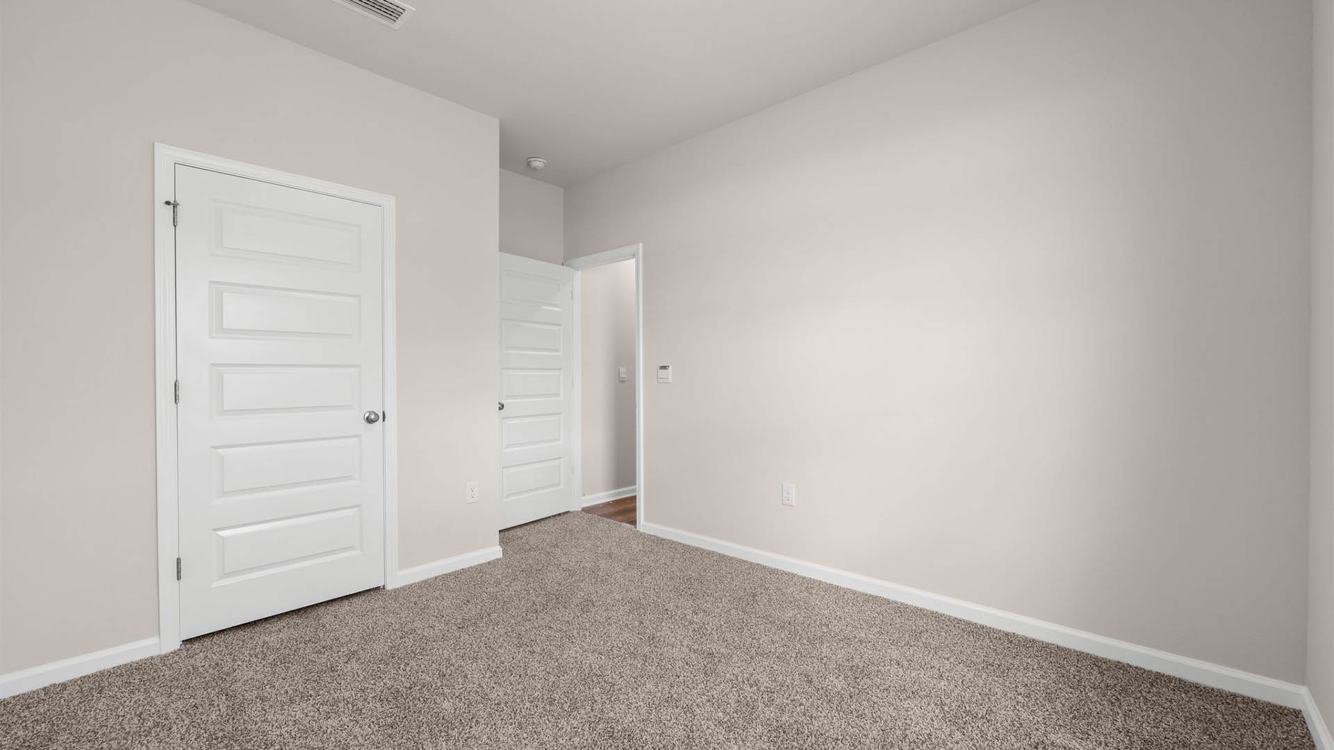 Bedroom with carpet floor and closet.