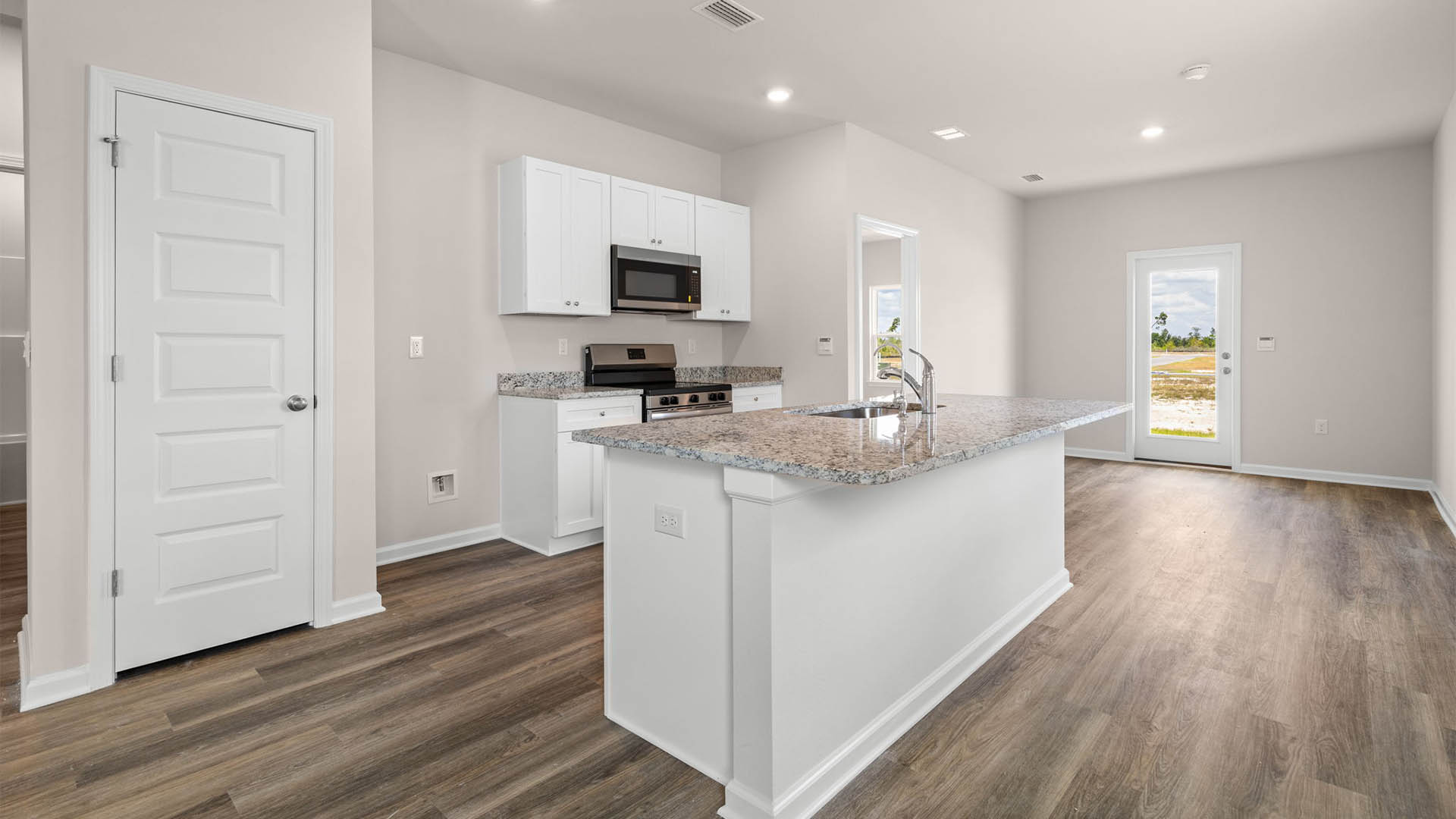 Kitchen with granite countertops and stainless-steel appliances and pantry.