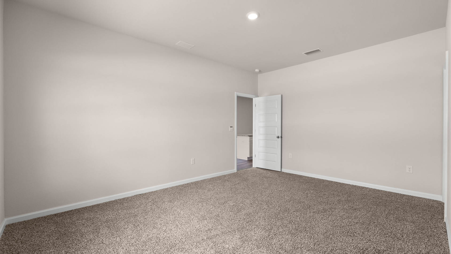 Primary bedroom with carpet floor and entrance.