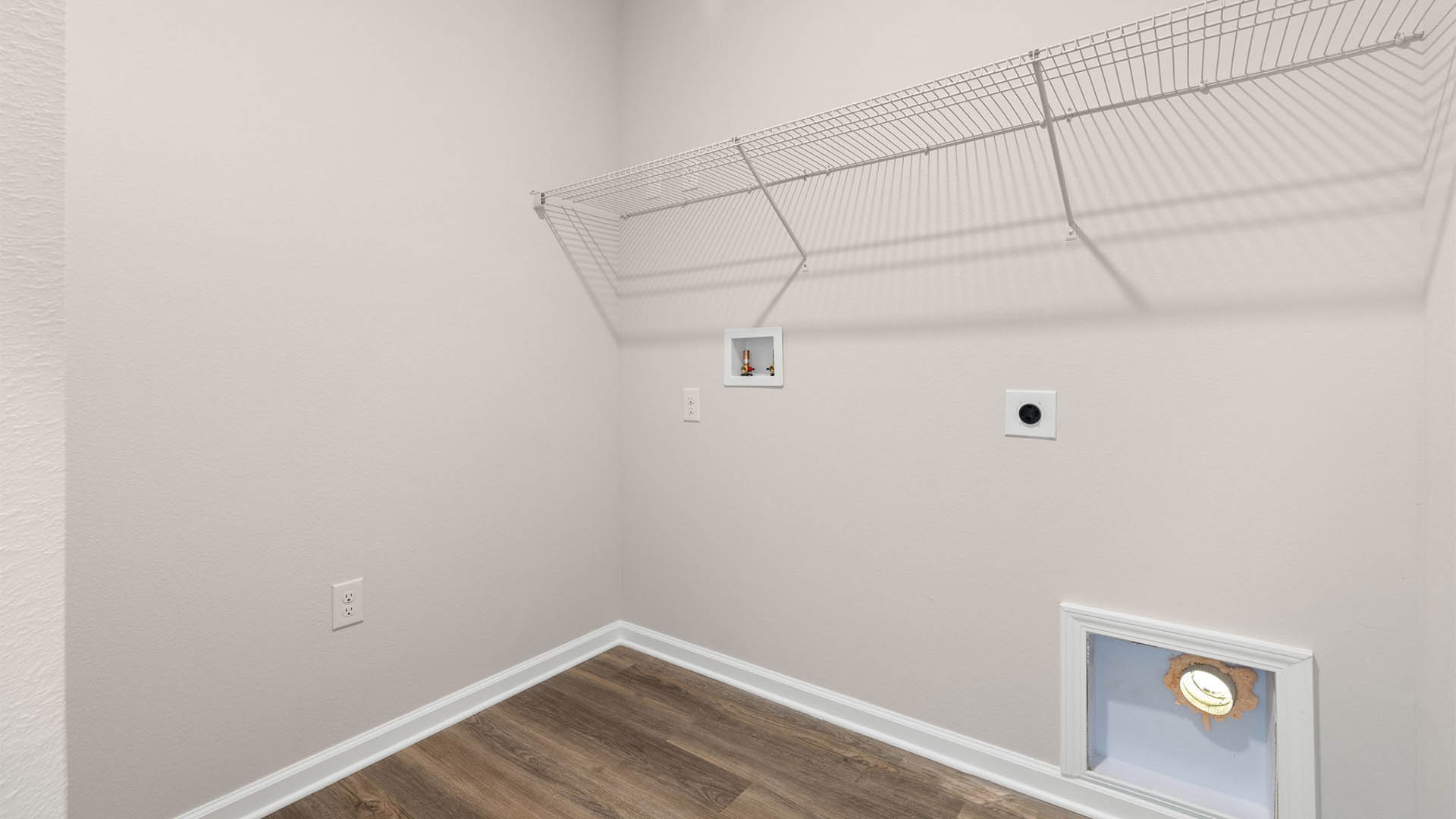 Laundry room with EVP flooring and shelving.