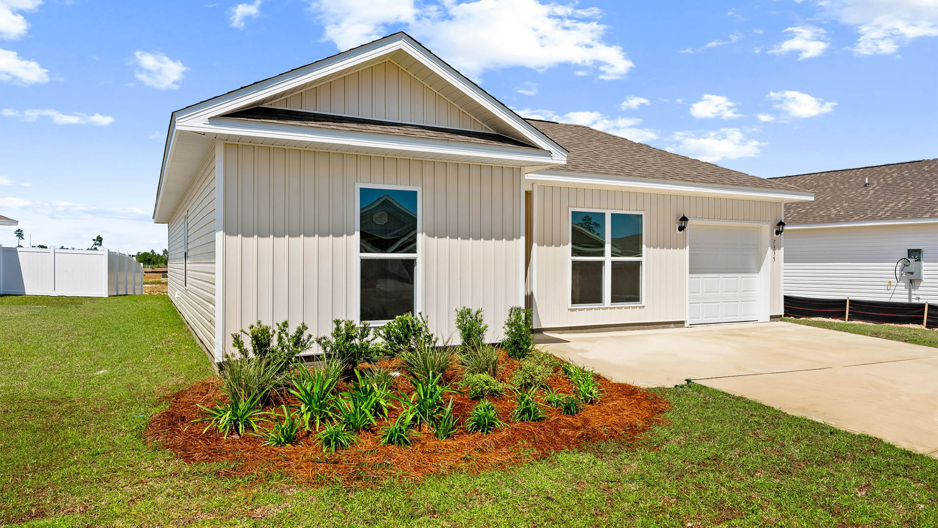 Sutton plan with vinyl siding and single-car garage.