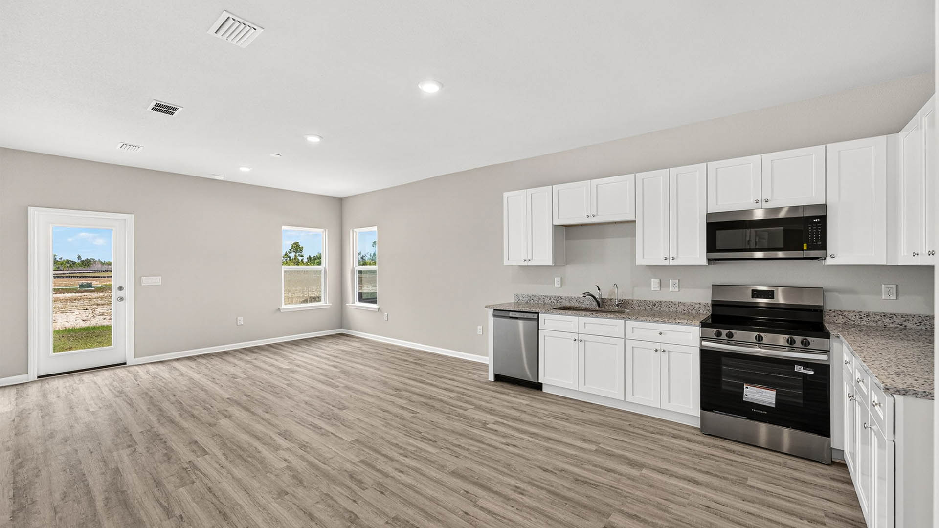 Open living room and kitchen with EVP flooring.