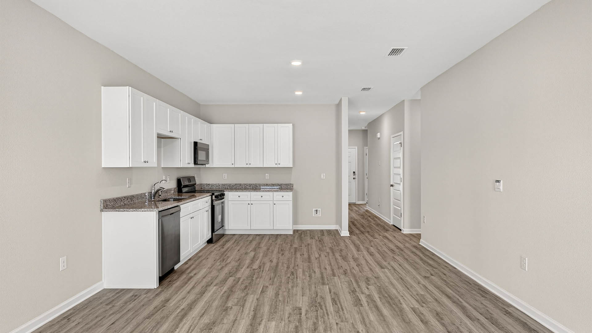 Open living room and kitchen with EVP flooring.