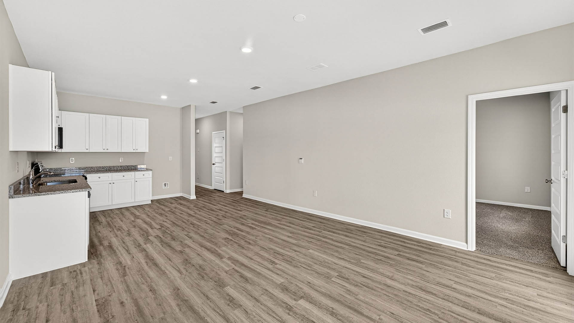 Open living room and kitchen with EVP flooring.